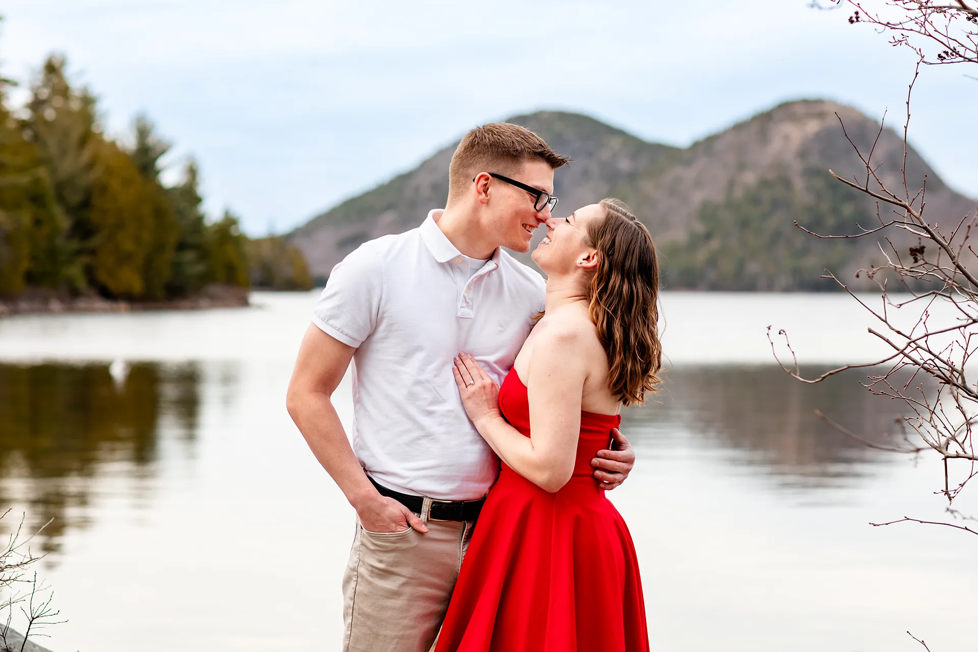 maine engagement photography chelsea mike 04 An engaged couple laughs and rub noses during an engagement session at Jordan Pond in Acadia National Park, Maine.