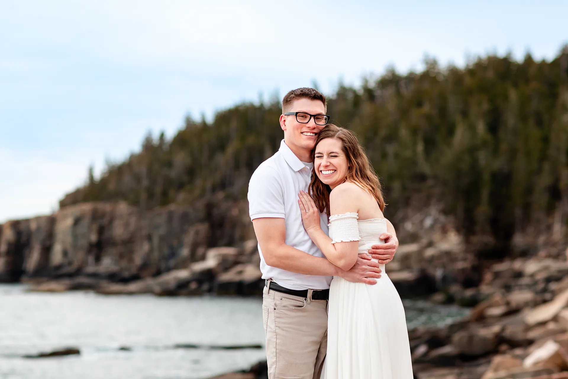 maine engagement photography chelsea mike 16 A man smiles as a woman laughs during an engagement session near Otter Cliff in Acadia National Park, Maine.