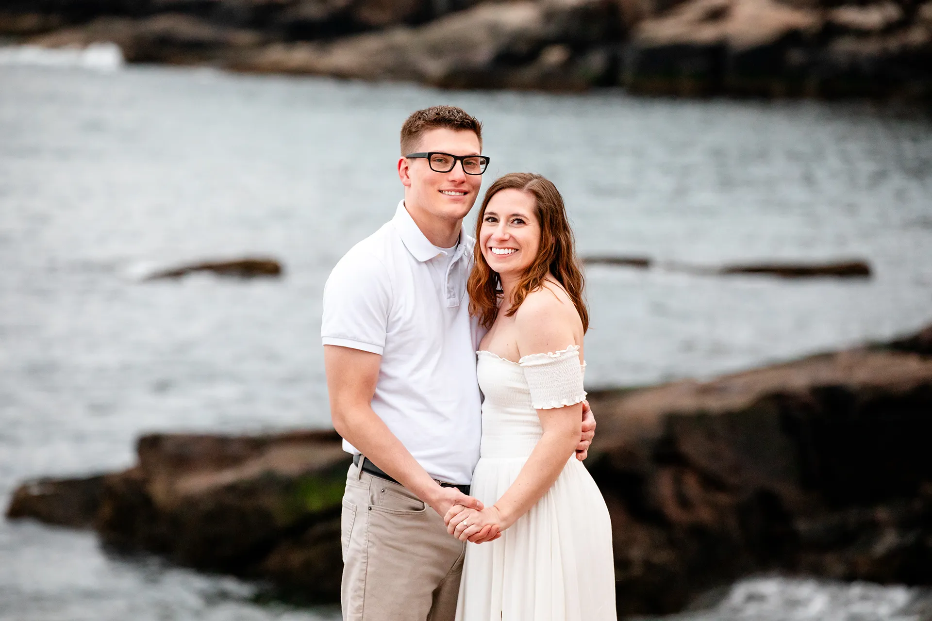 maine engagement photography chelsea mike 20 An engaged couple smile and pose during an engagement session near Otter Cliff in Acadia National Park, Maine.
