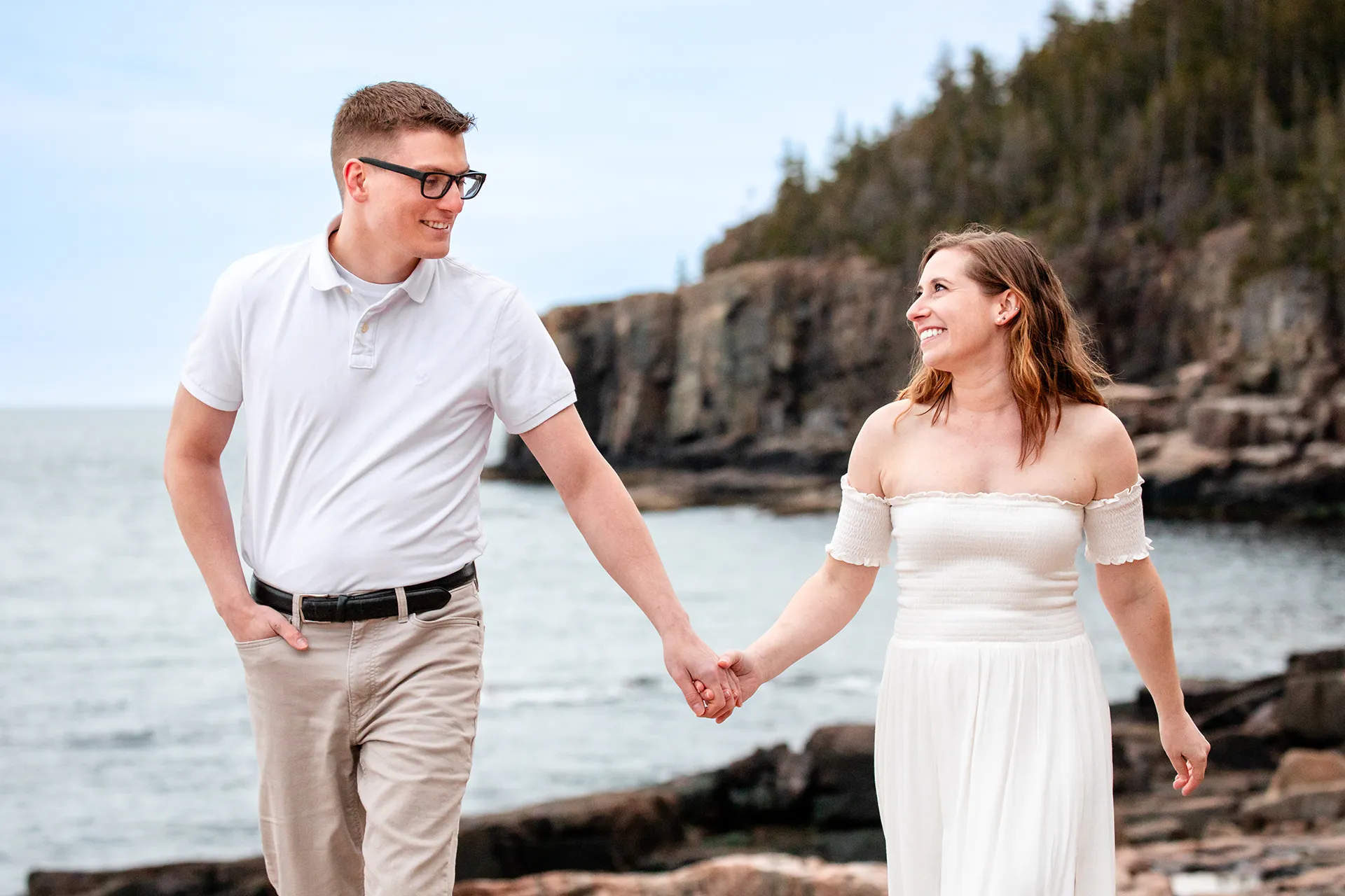 maine engagement photography chelsea mike 23 An engaged couple hold hands and smiles during an engagement session near Otter Cliff in Acadia National Park, Maine.