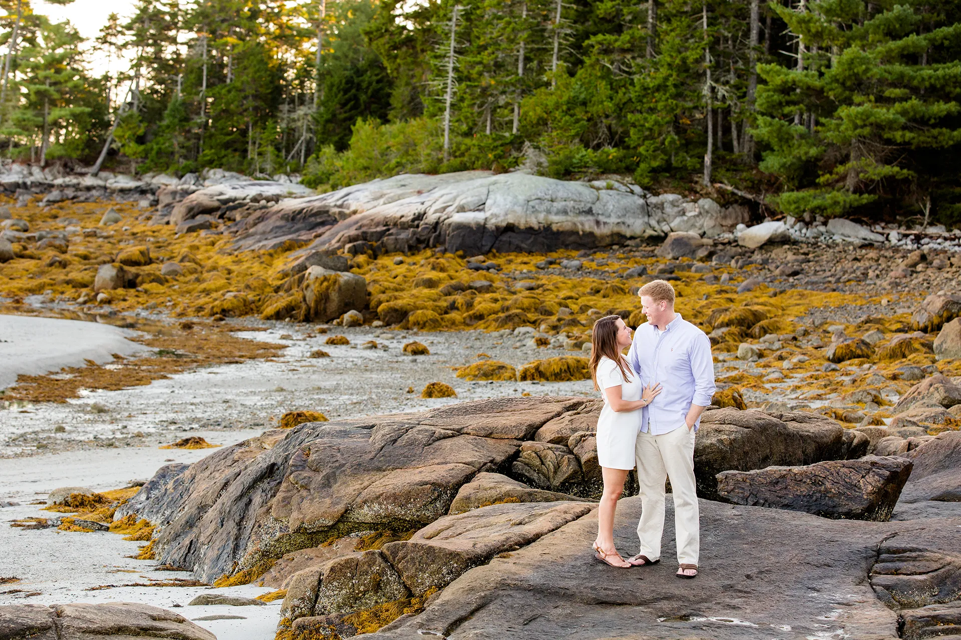 maine engagement photography stephanie nick 03 An engaged couple smile at each other during an engagement session at Curtis Cove in Blue Hill, Maine.