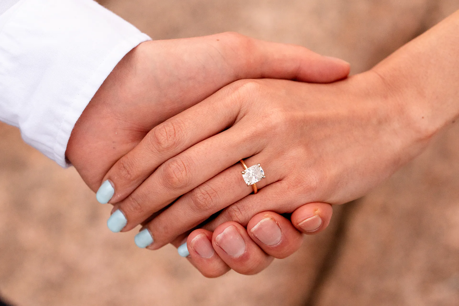 A closeup of a woman's hand wearing an engagement ring during a portrait session in Acadia National Park near Bar Harbor, Maine.