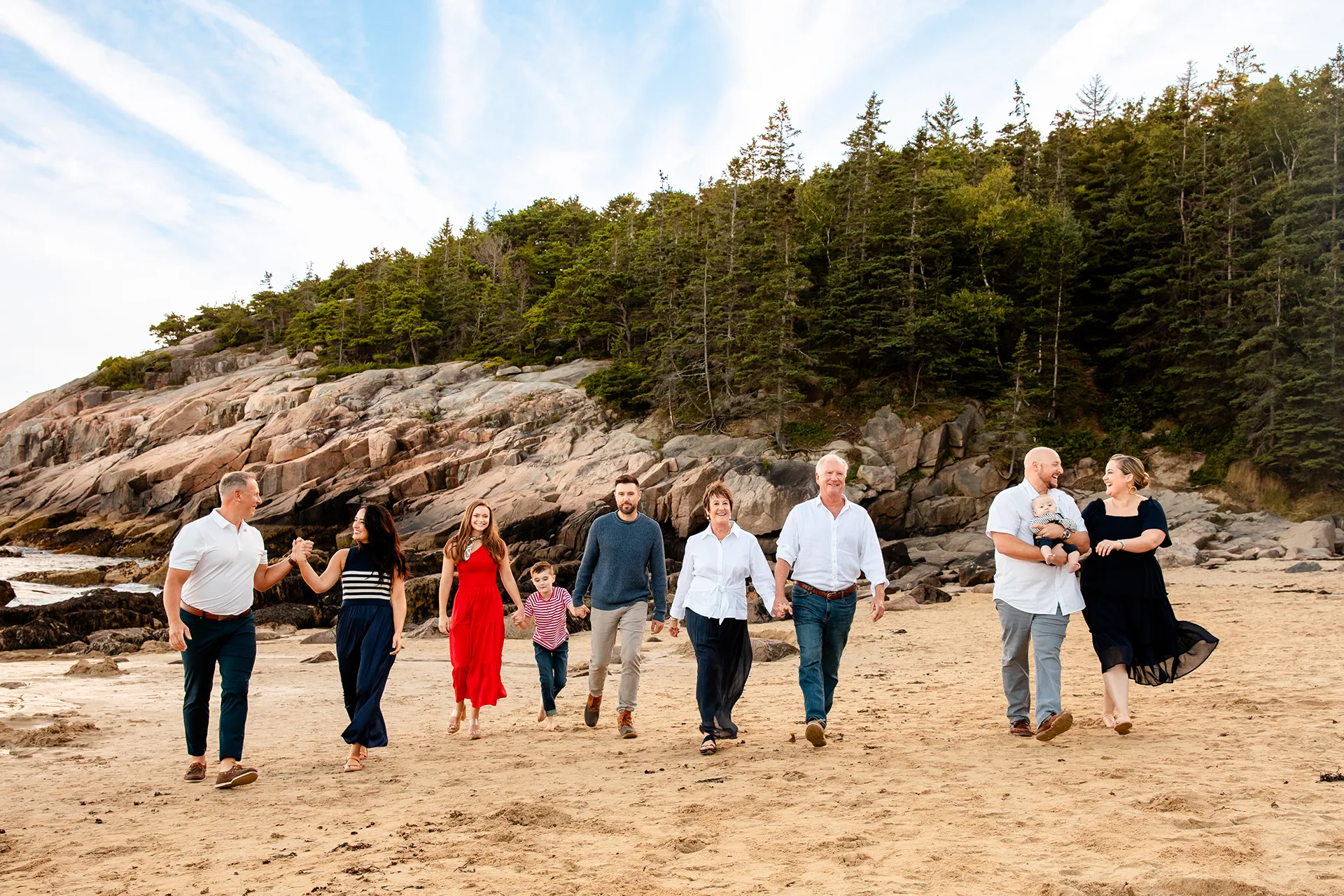 maine family photography daehler 01 An extended family holds hands and walks on Sand Beach during a portrait session in Acadia National Park near Bar Harbor, Maine.