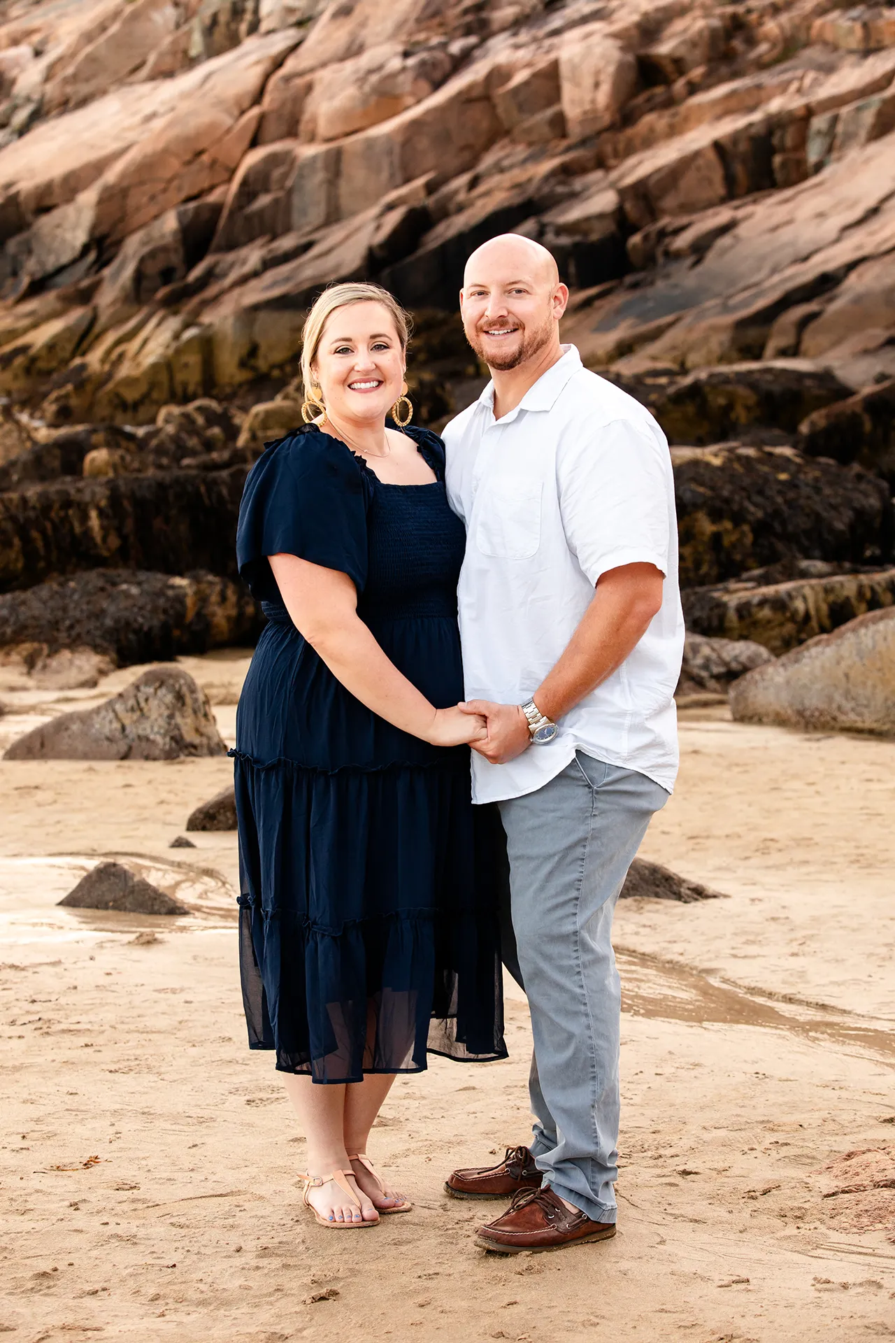 maine family photography daehler 04 A married couple hold hands and smile during a family portrait session on Sand Beach in Acadia National Park near Bar Harbor, Maine.