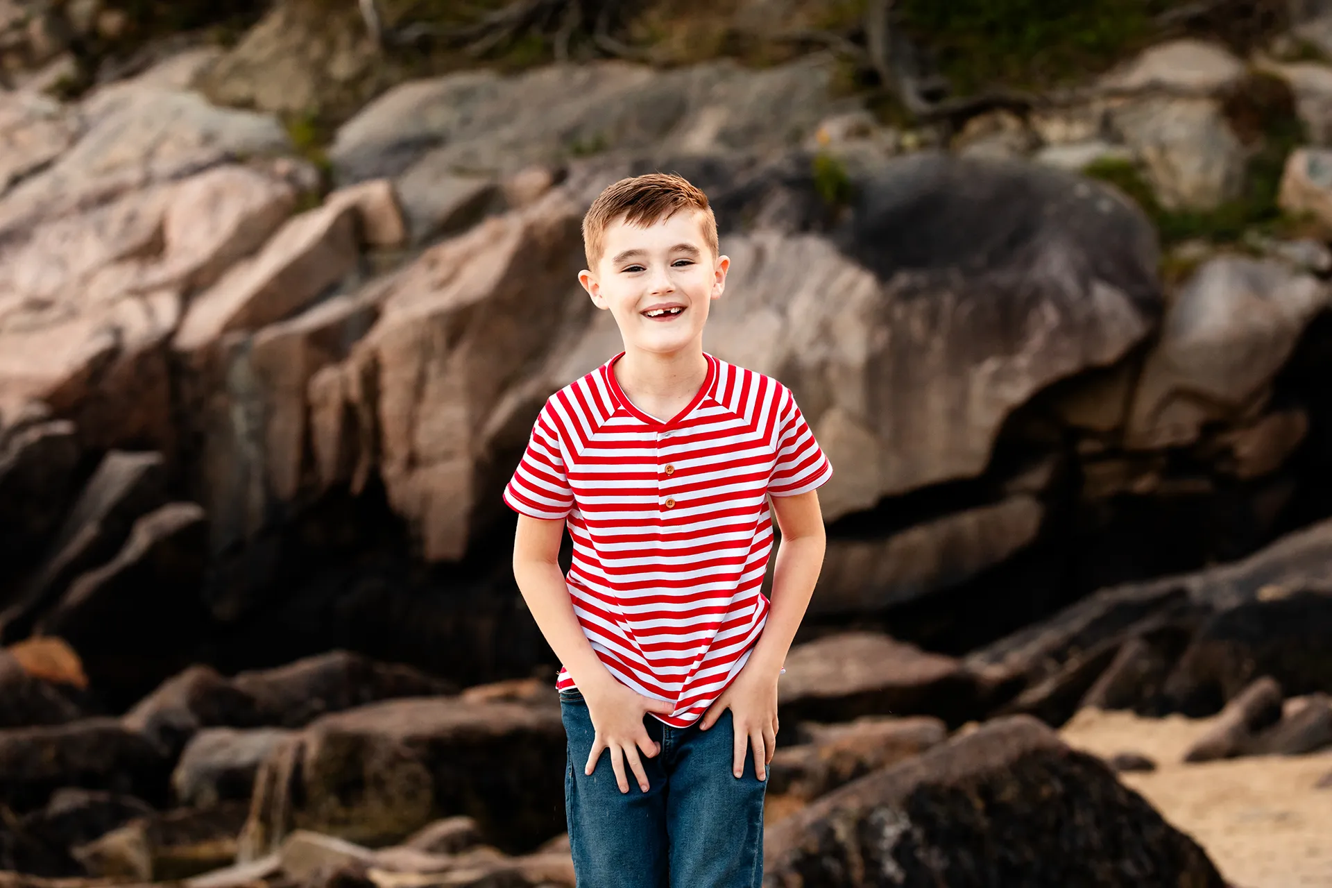 maine family photography daehler 07 A boy smiles and laughs during a family portrait session on Sand Beach in Acadia National Park near Bar Harbor, Maine.