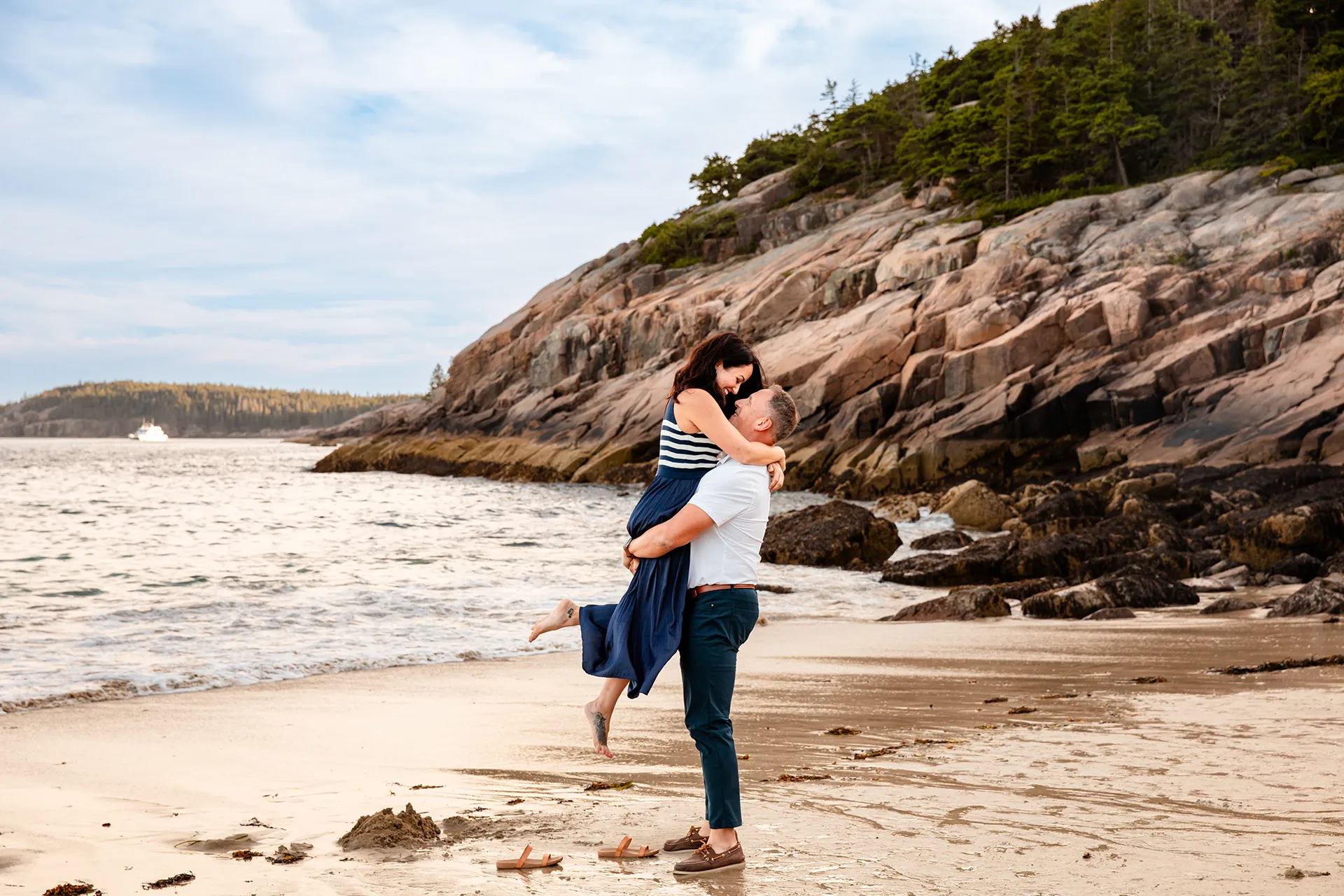 maine family photography daehler 11 A man picks up a woman during a family portrait session on Sand Beach in Acadia National Park near Bar Harbor, Maine.