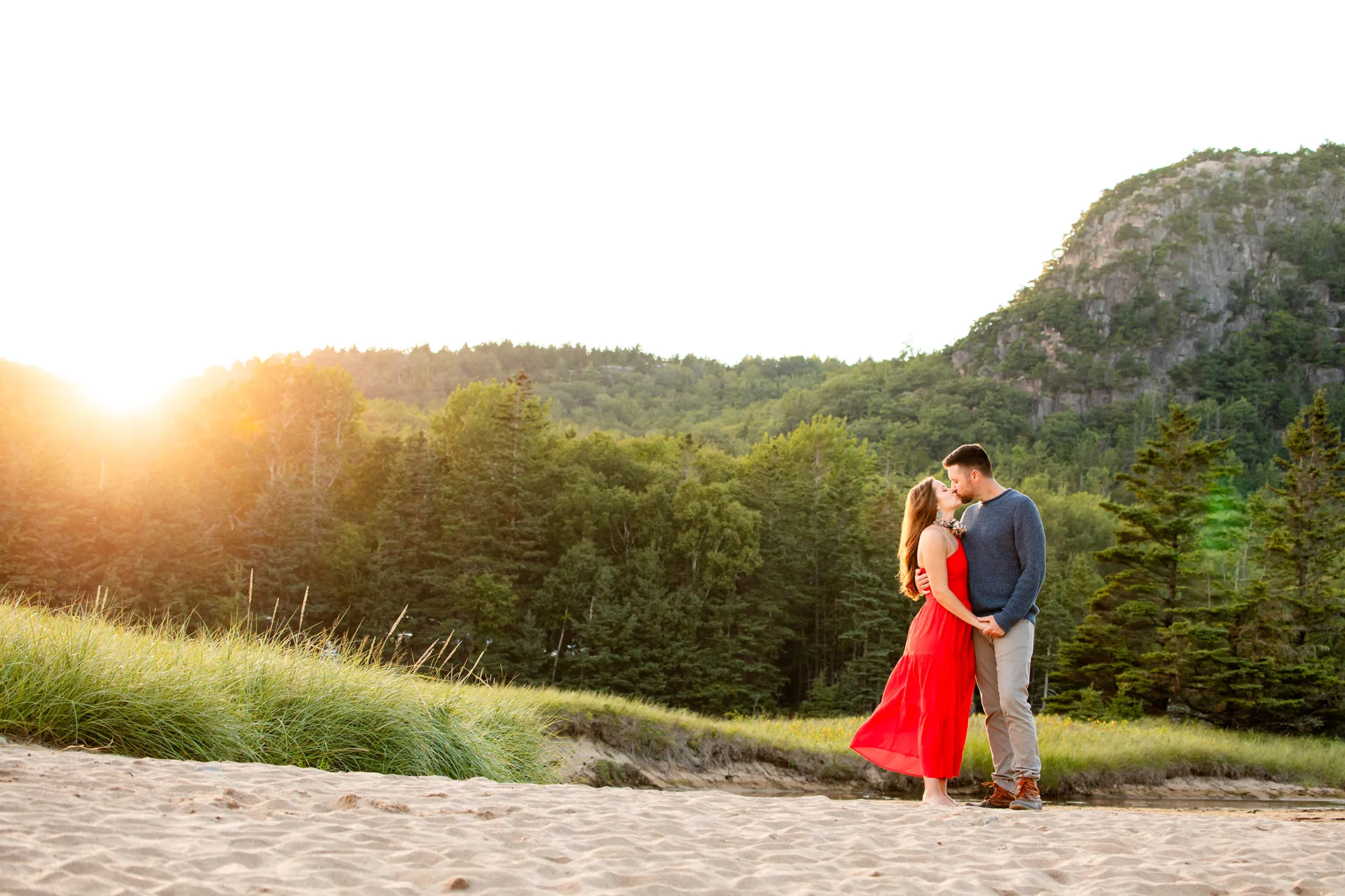 maine family photography daehler 14 A man and woman hold hands and kiss during a family portrait session on Sand Beach in Acadia National Park near Bar Harbor, Maine.