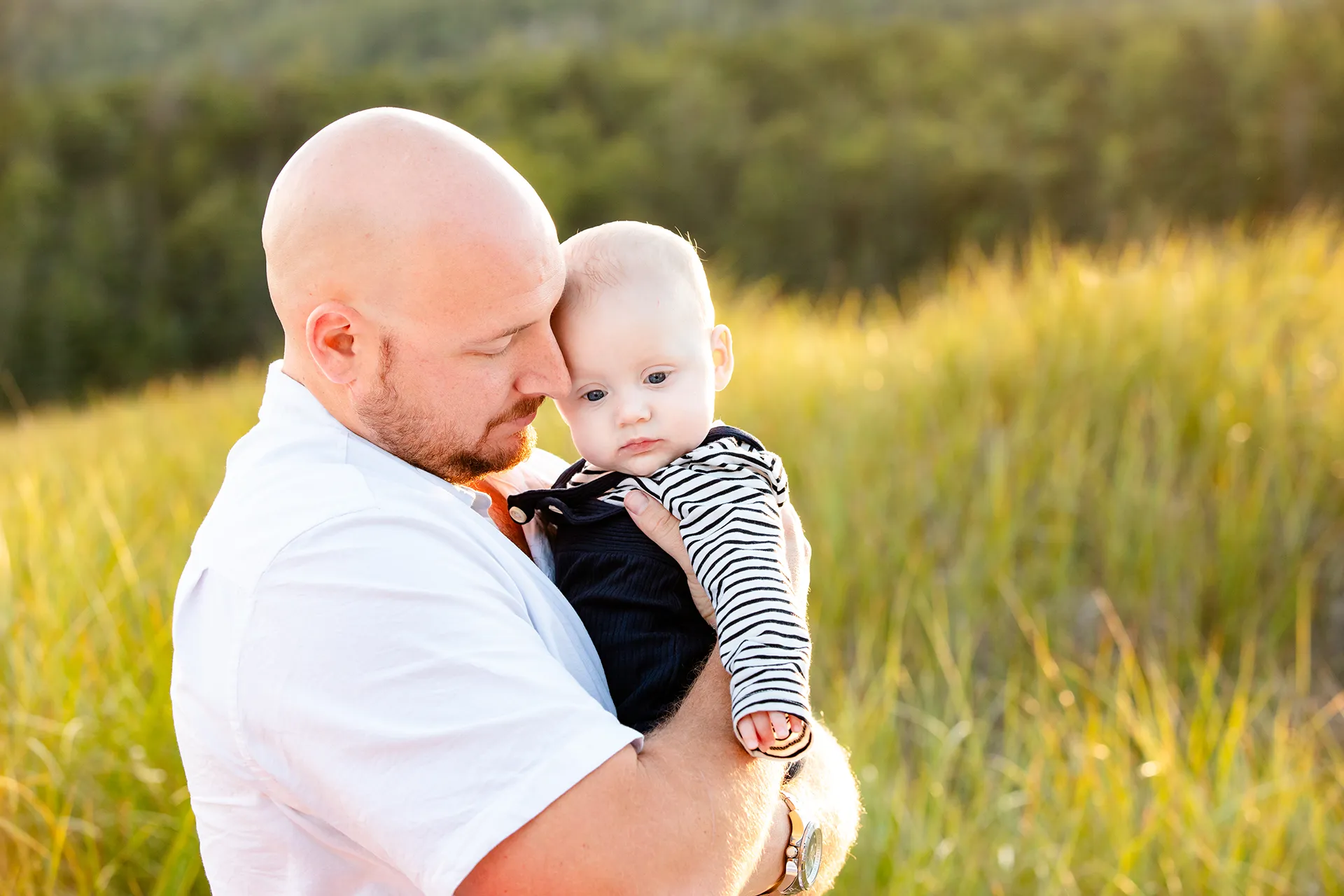 maine family photography daehler 15 A dad snuggles with his son during a family portrait session on Sand Beach in Acadia National Park near Bar Harbor, Maine.