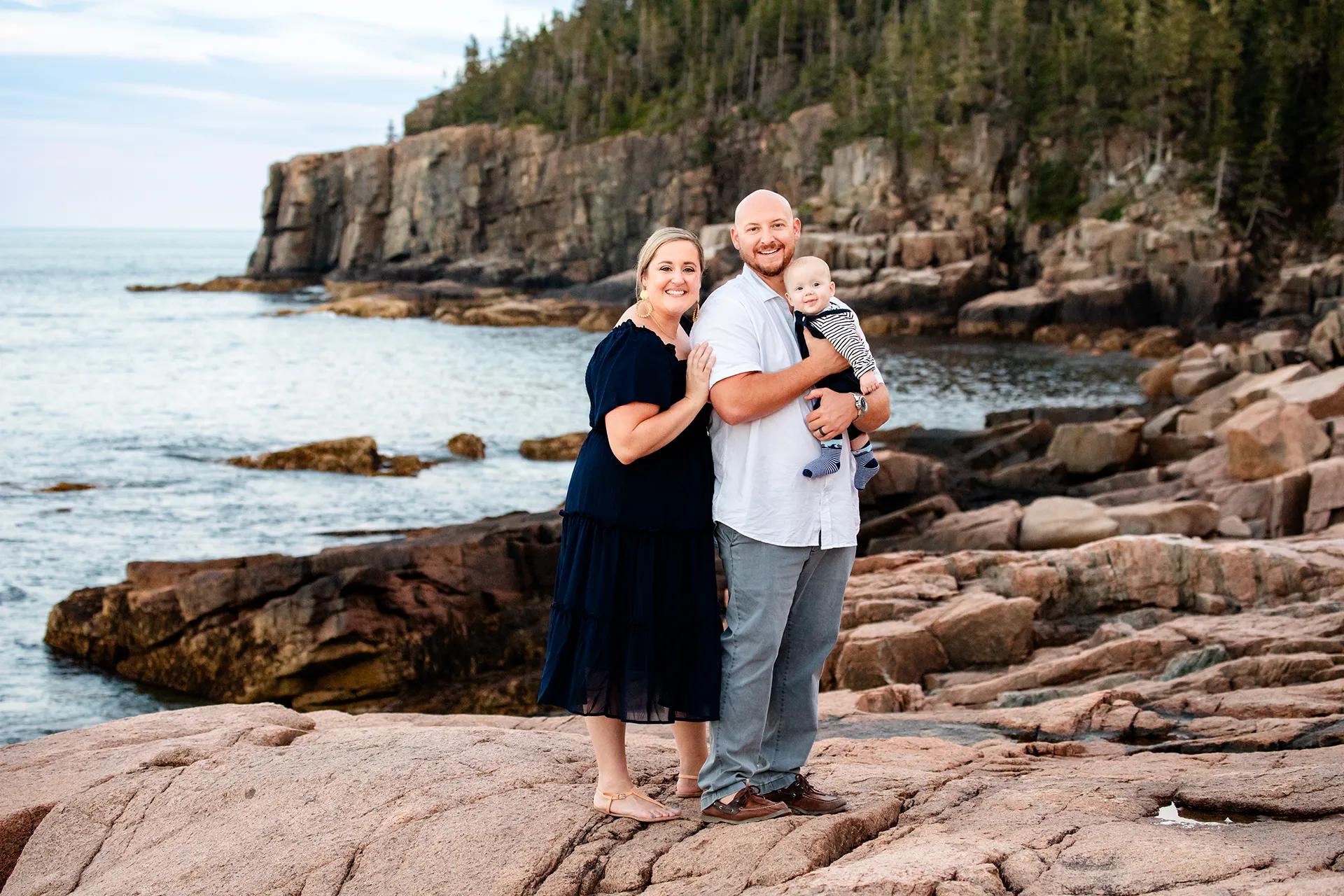 maine family photography daehler 19 A mom, dad, and their son smile and pose during a family portrait session at Ocean Path Trail in Acadia National Park near Bar Harbor, Maine.