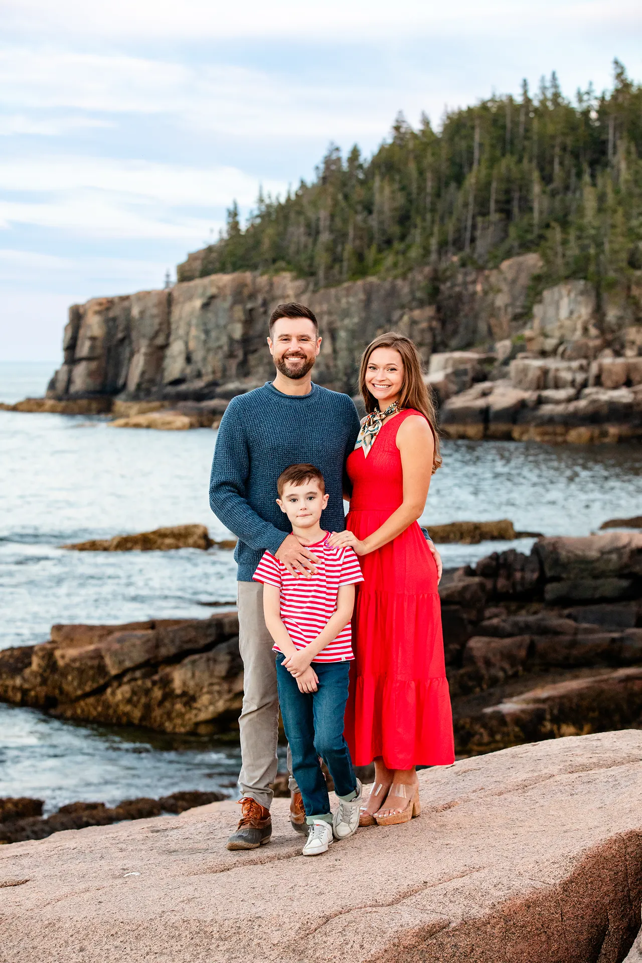 maine family photography daehler 25 A mom, dad, and their son smile and pose during a family portrait session at Otter Cliff in Acadia National Park near Bar Harbor, Maine.