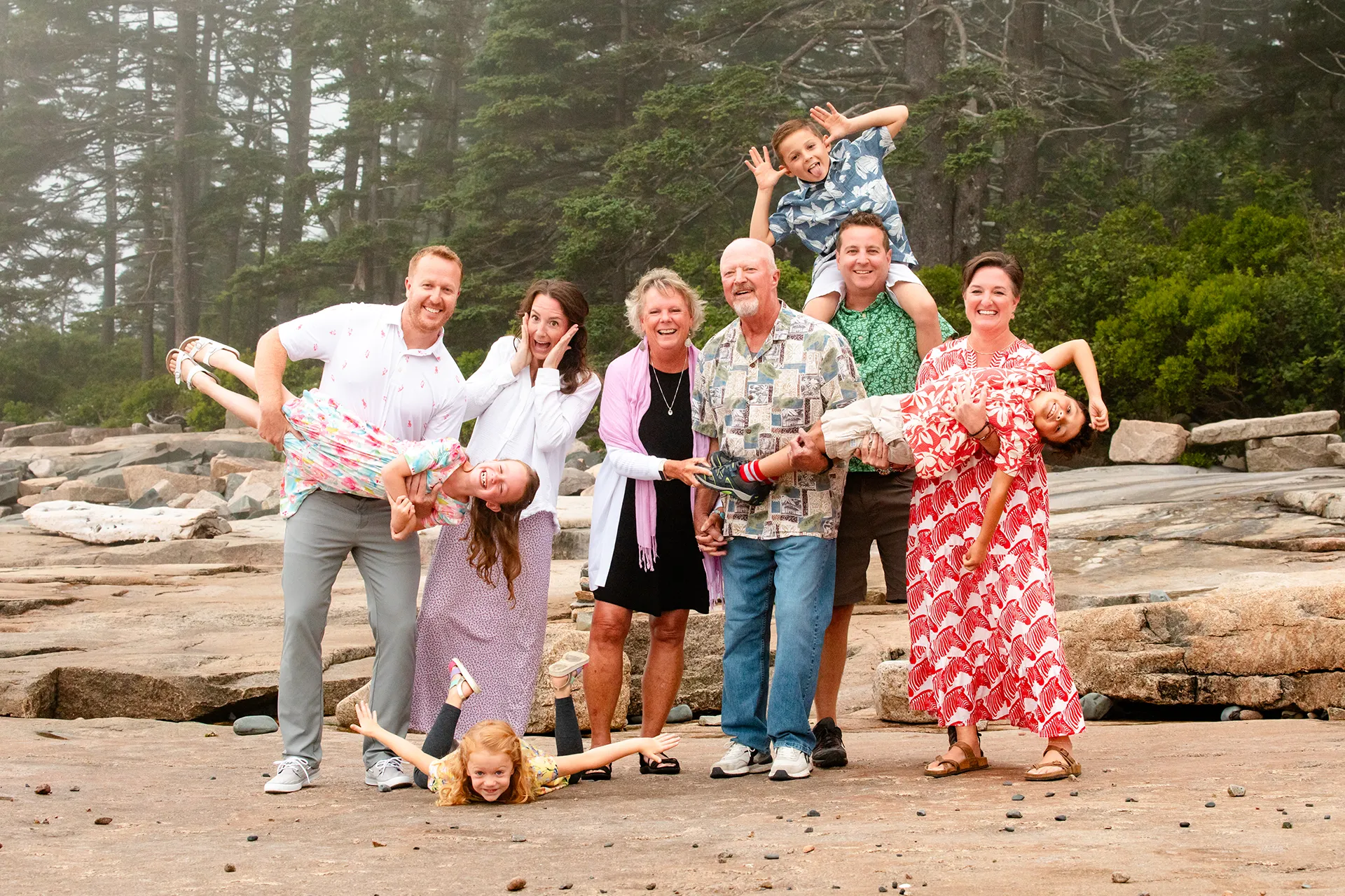 An extend family make funny faces during a family portrait session at Grindstone Point in Winter Harbor, Maine.