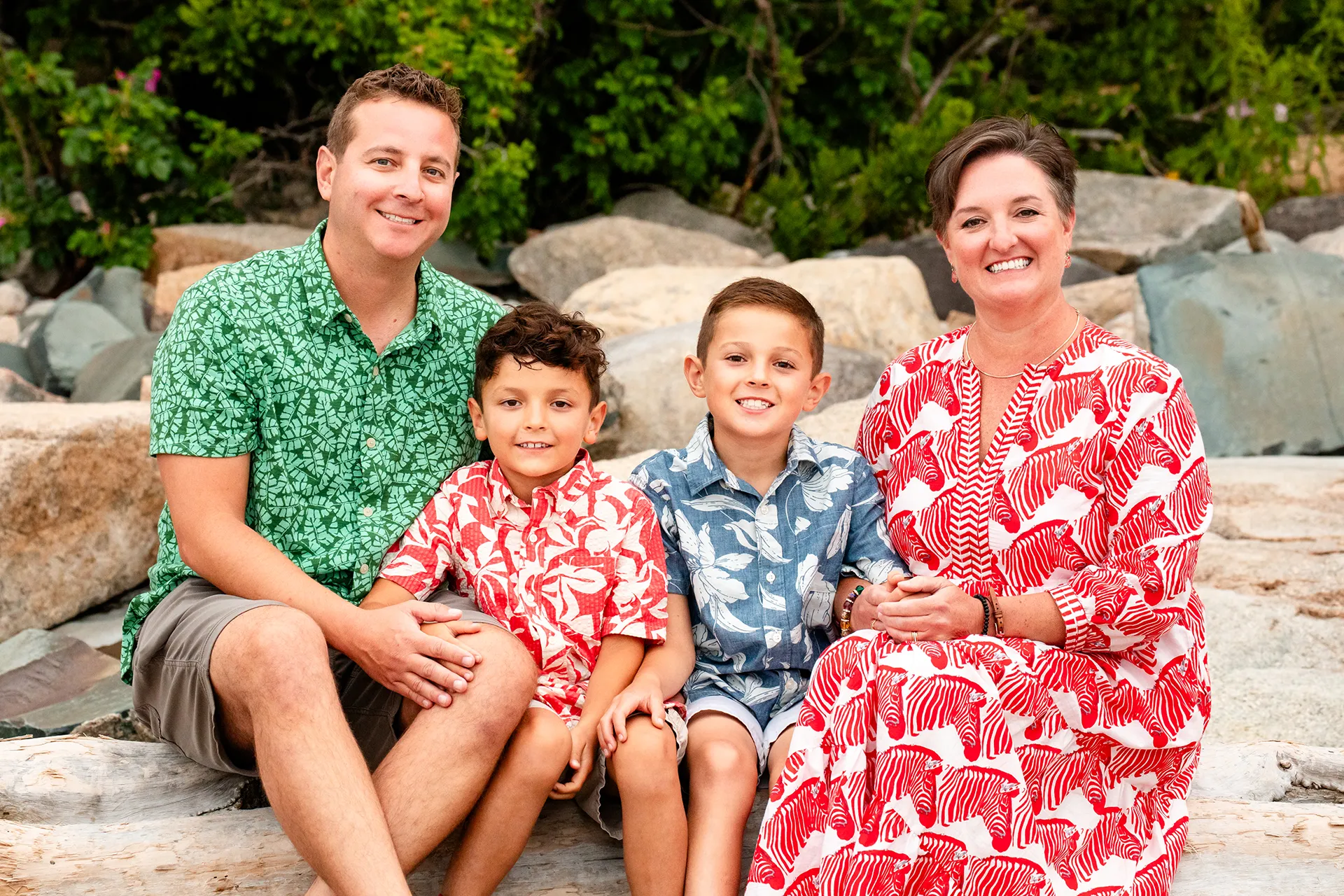 A family sits and poses for family portraits at Grindstone Point in Winter Harbor, Maine.