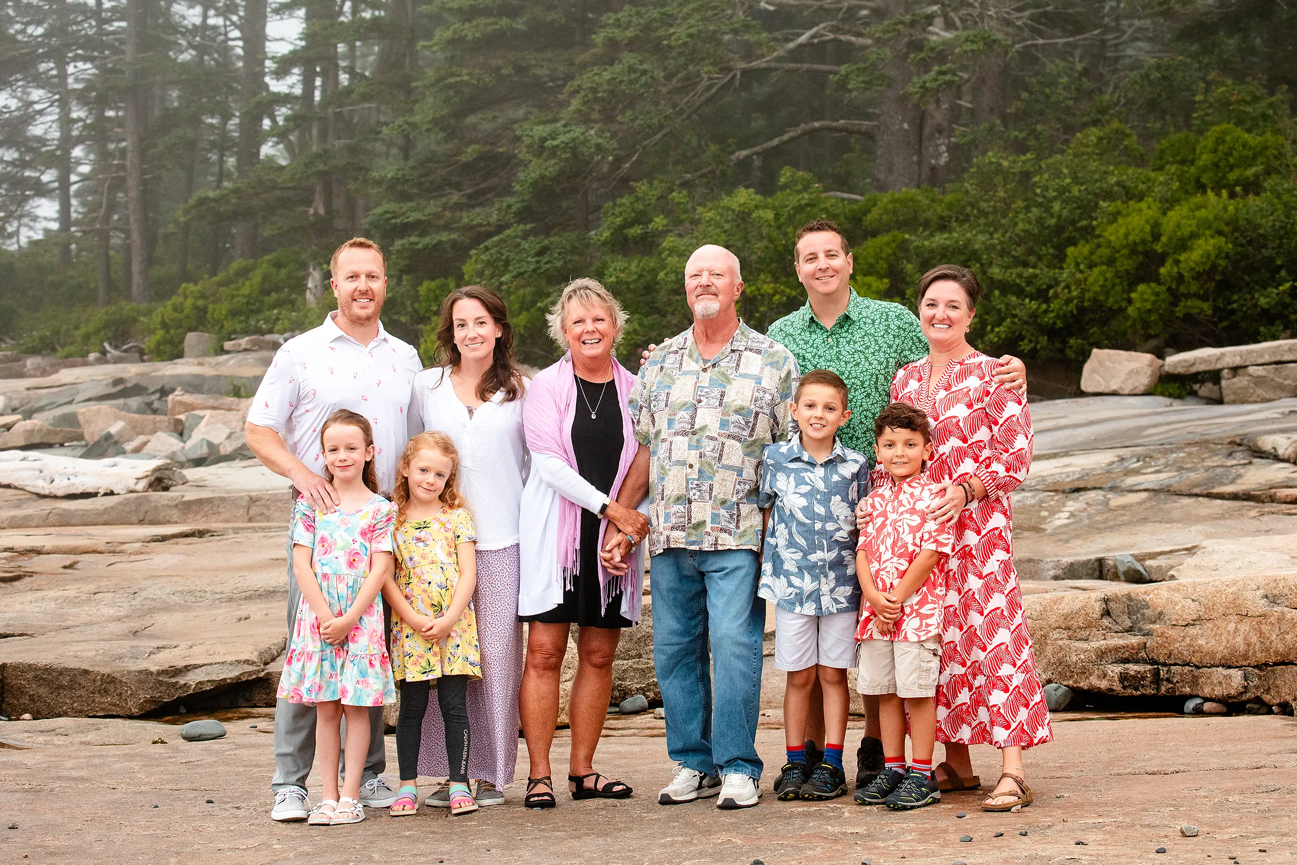An extend family smile and pose at Grindstone Point in Winter Harbor, Maine during a family portrait session.