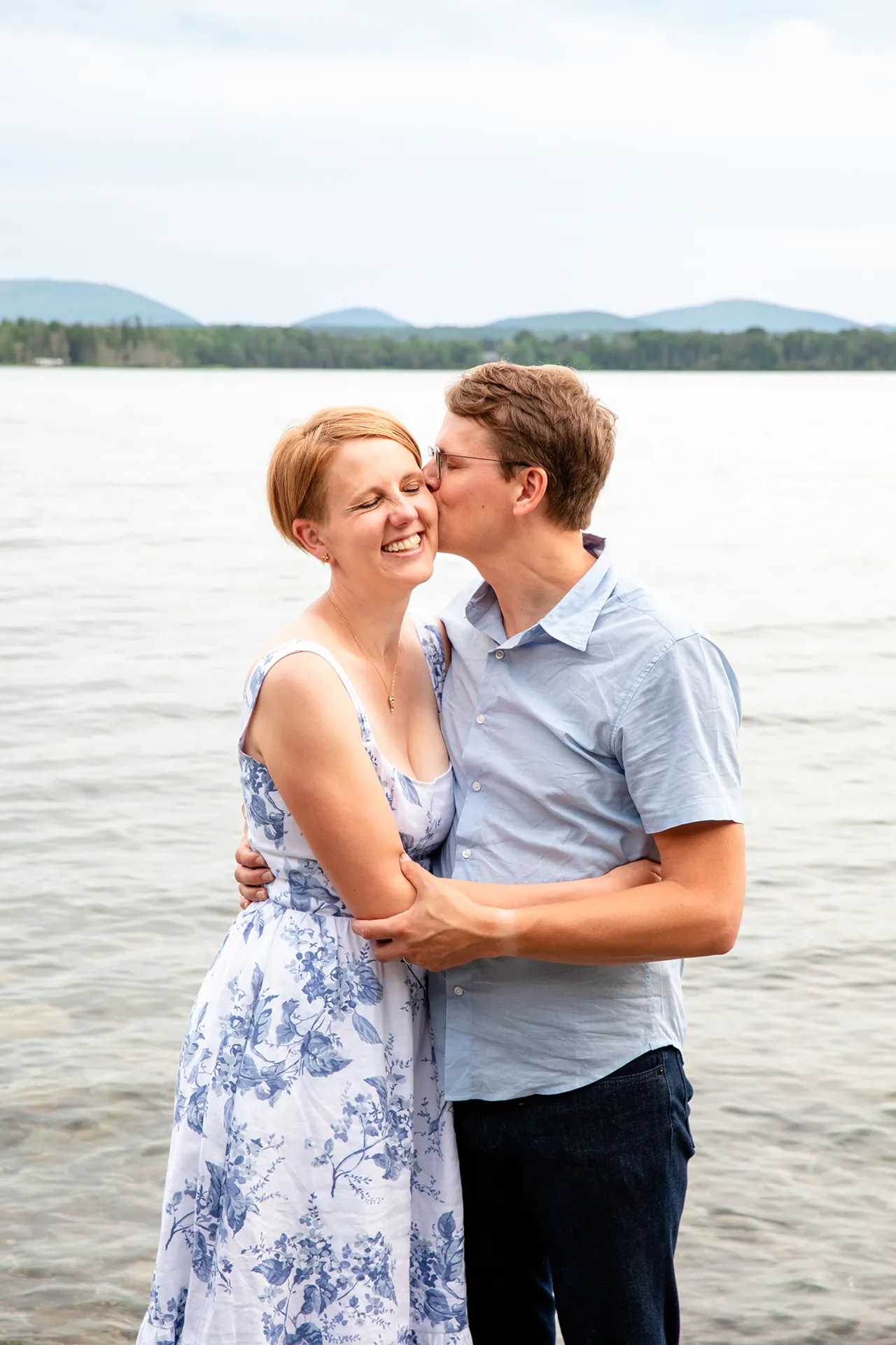 maine family photography moldawer mandsager 14 A man kisses a smiling woman on the cheek during a family portrait session in Lamoine, Maine.