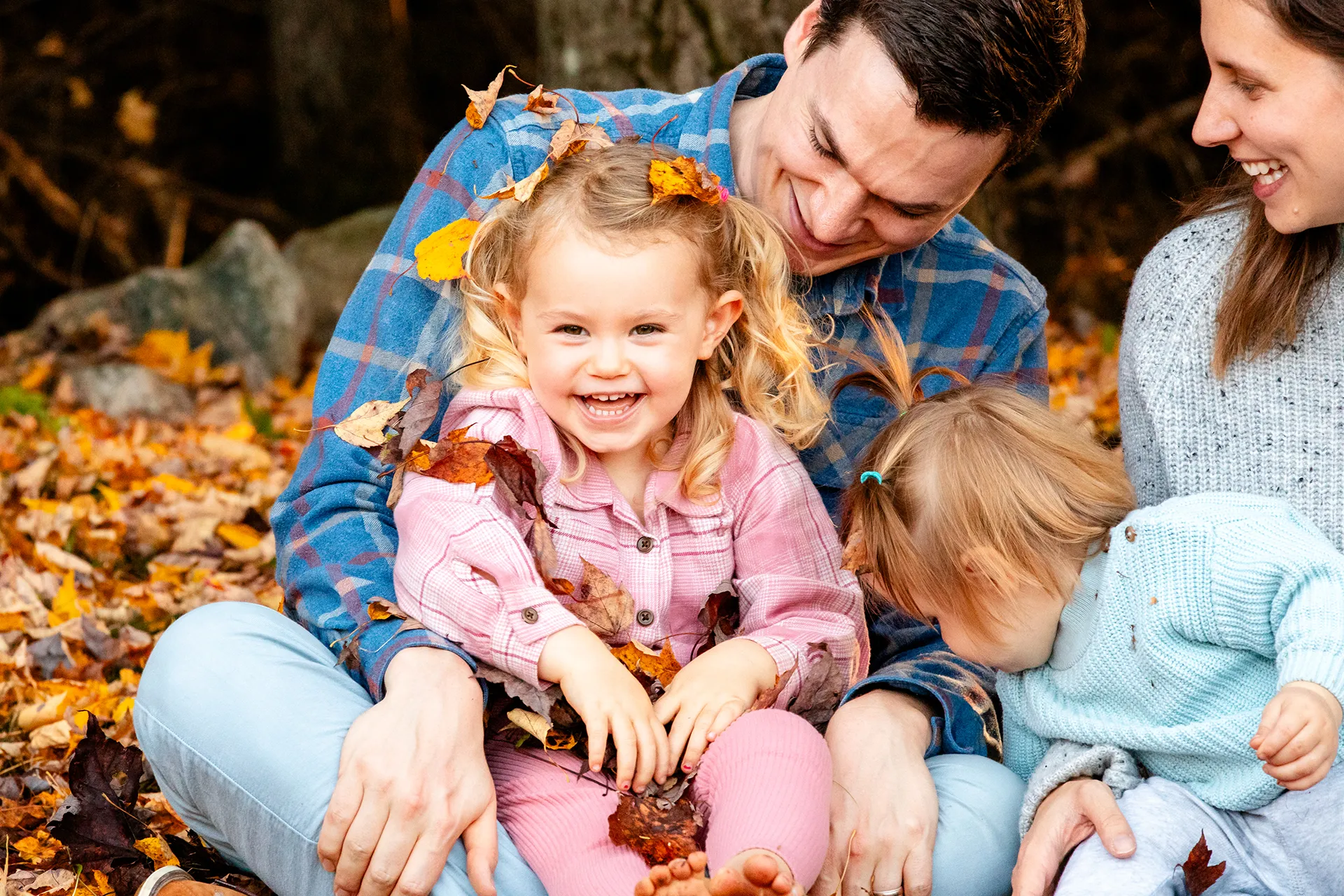 maine family photography sleeper wolland 06 A girl laughs as she sits in her dad's lap during a fall family portrait session near Bangor, Maine.