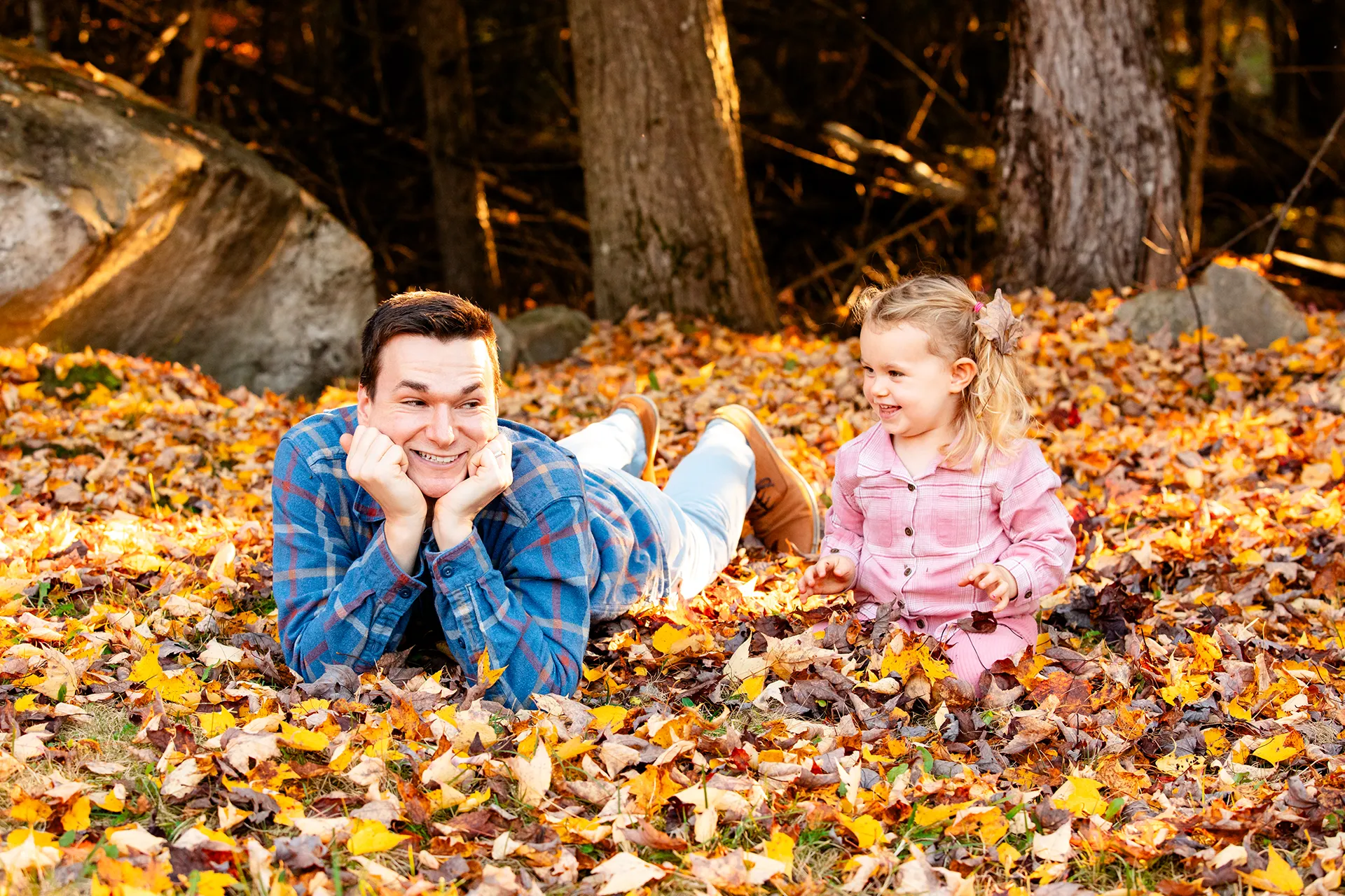 maine family photography sleeper wolland 07 A dad and daughter play in a pile of leaves during a fall family portrait session near Bangor, Maine.