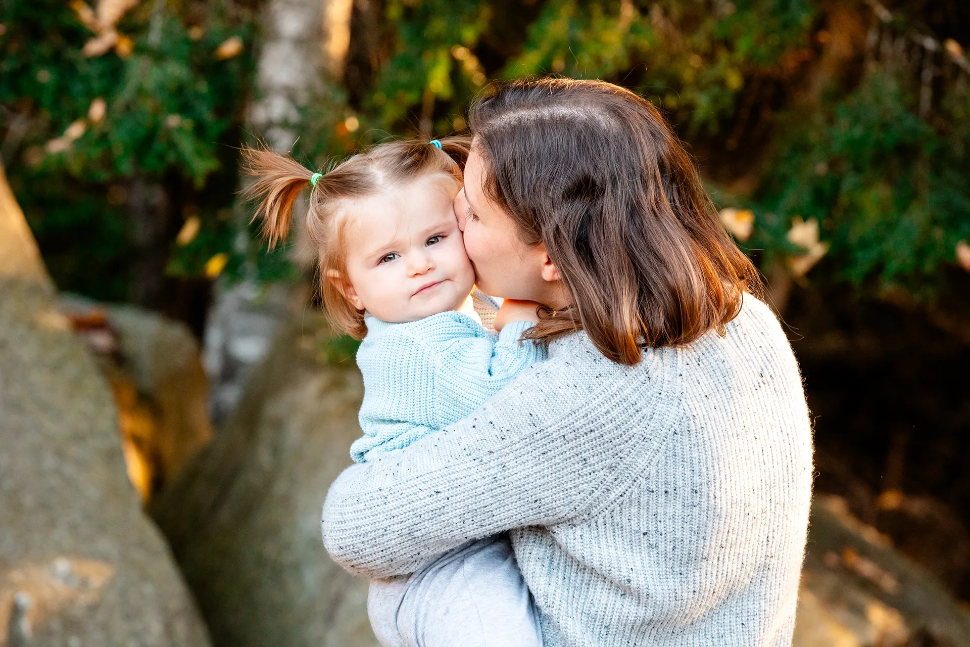 maine family photography sleeper wolland 10 A mom kisses her daughter on her cheek during a fall family portrait session near Bangor, Maine.