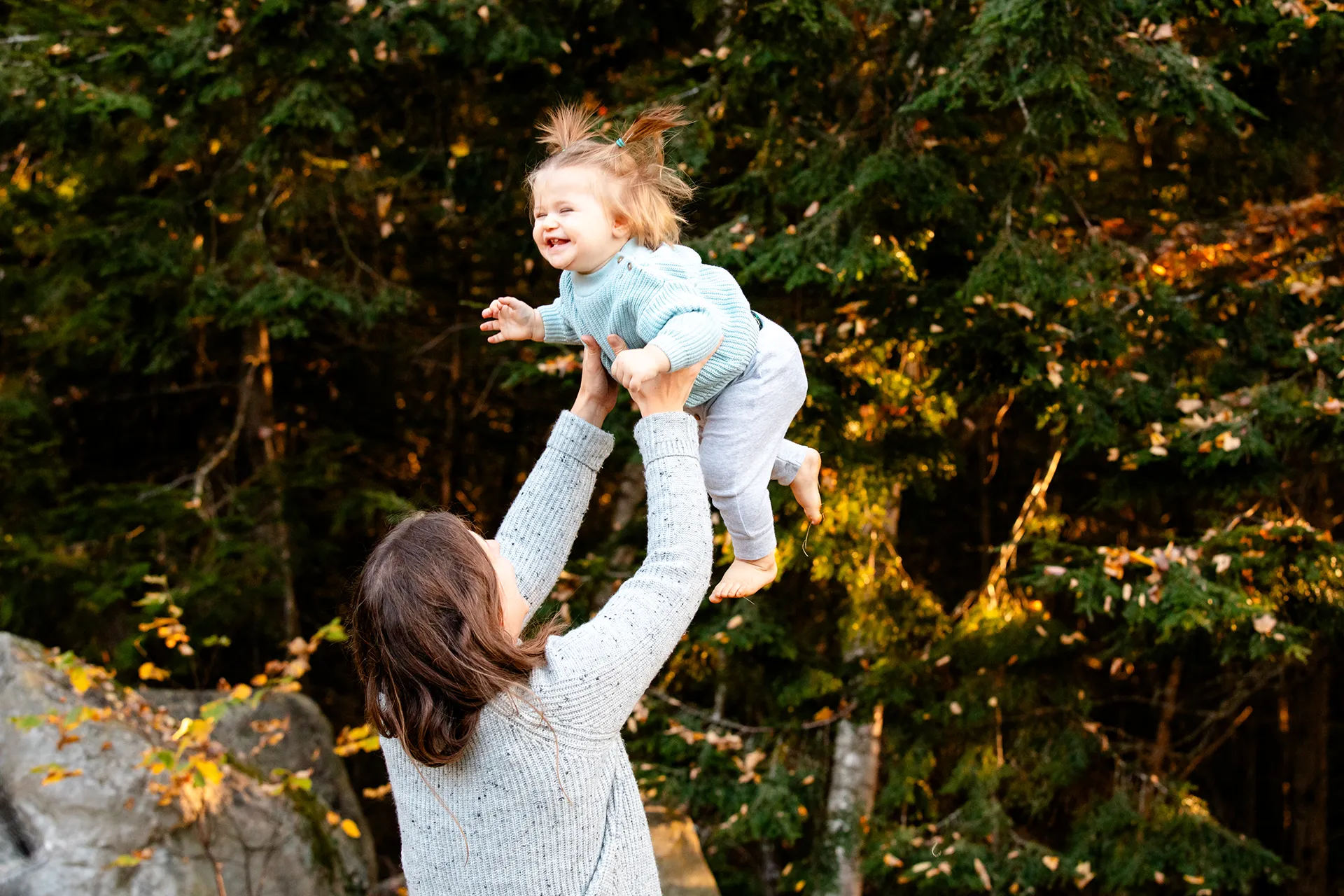 maine family photography sleeper wolland 11 A mom throws her daughter in the air as she laughs during a fall family portrait session near Bangor, Maine.