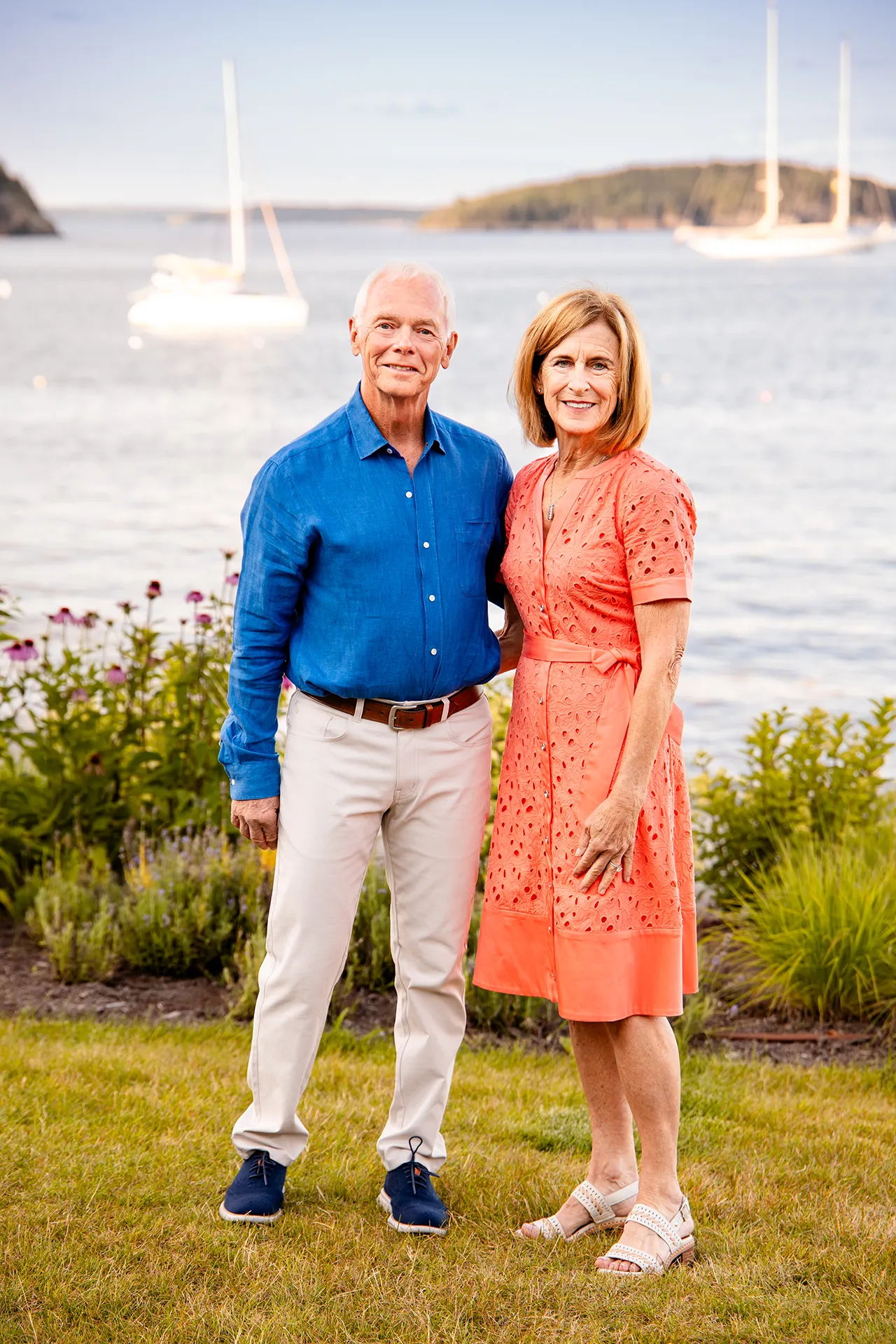 A man and woman smile and pose during a portrait session at the Bar Harbor Inn & Spa in Bar Harbor, Maine.