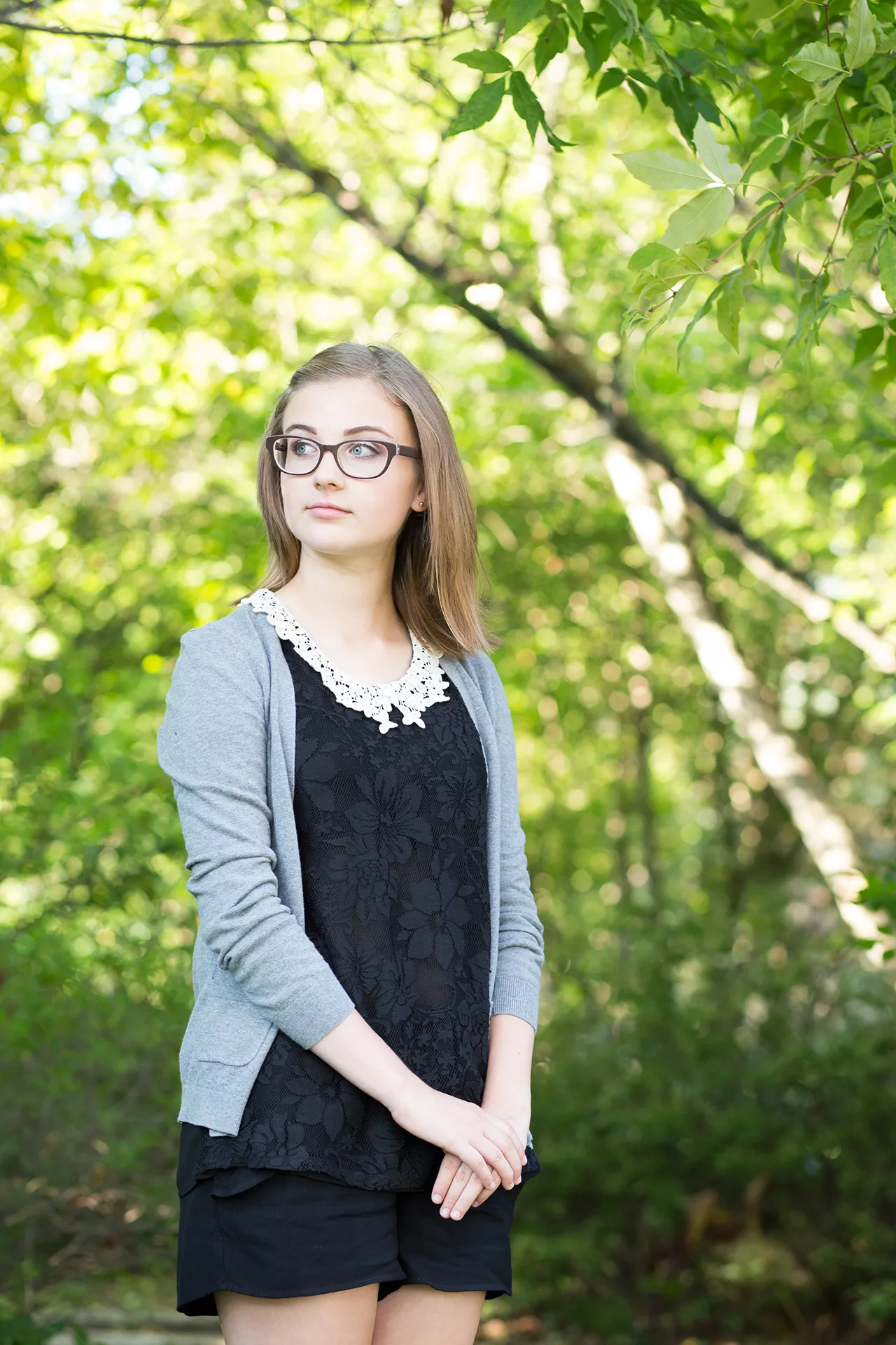 maine portrait photography emma 05 A girl poses in a garden during a senior portrait session at the University of Maine in Orono.