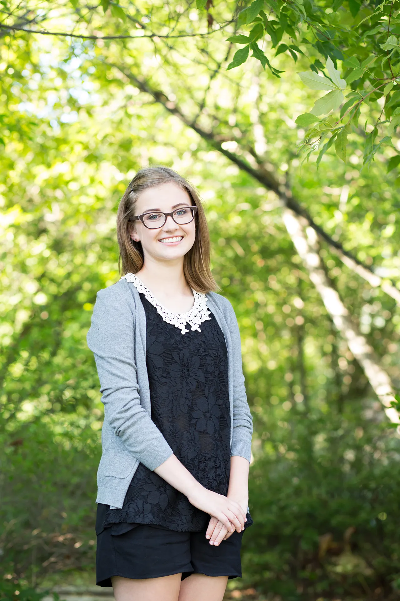maine portrait photography emma 06 A high school senior smiles and poses during a portrait session in Littlefield Ornamental Garden at the University of Maine in Orono.