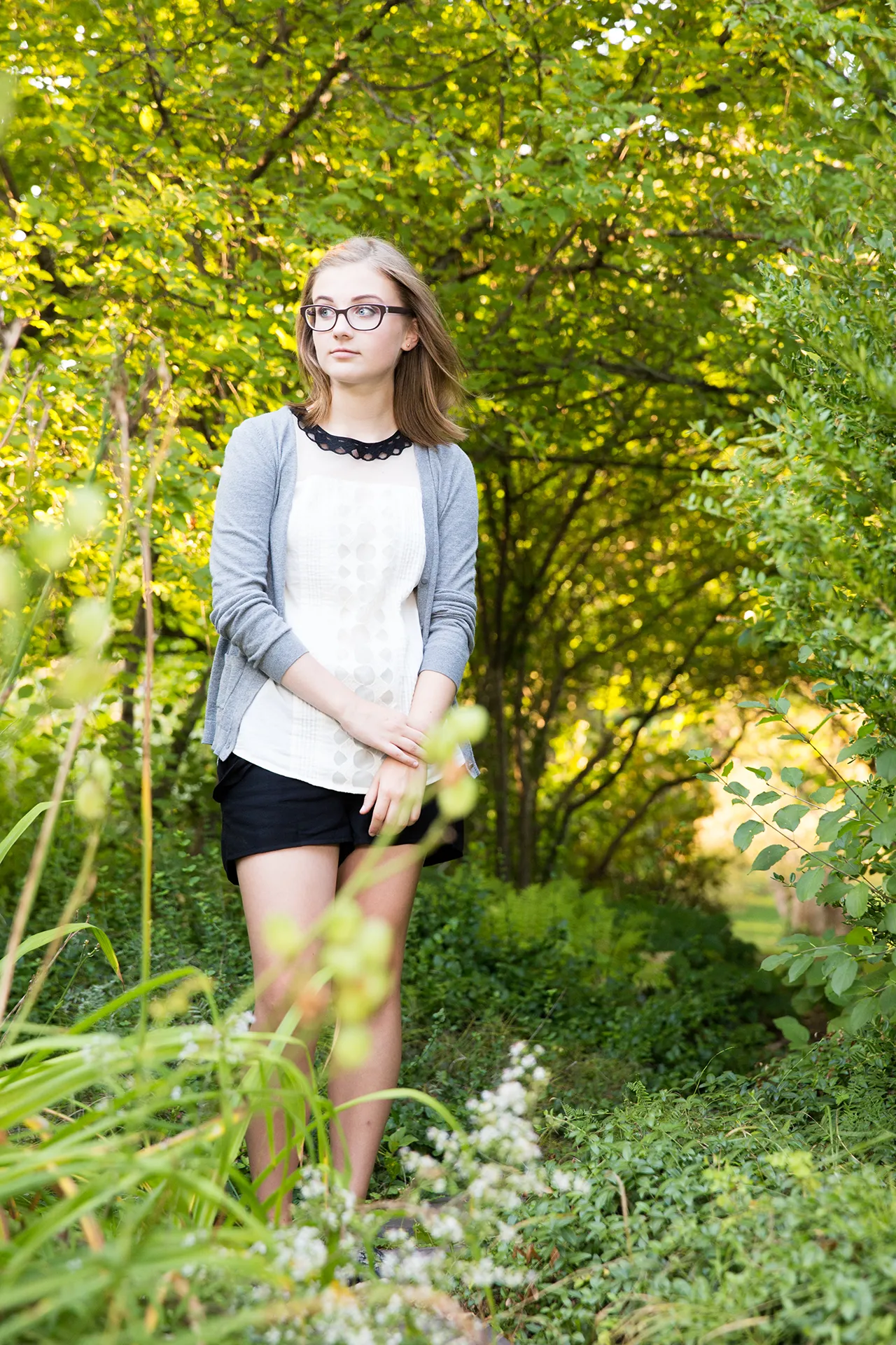 maine portrait photography emma 09 A high school senior poses in a garden during a senior portrait session at the University of Maine in Orono.