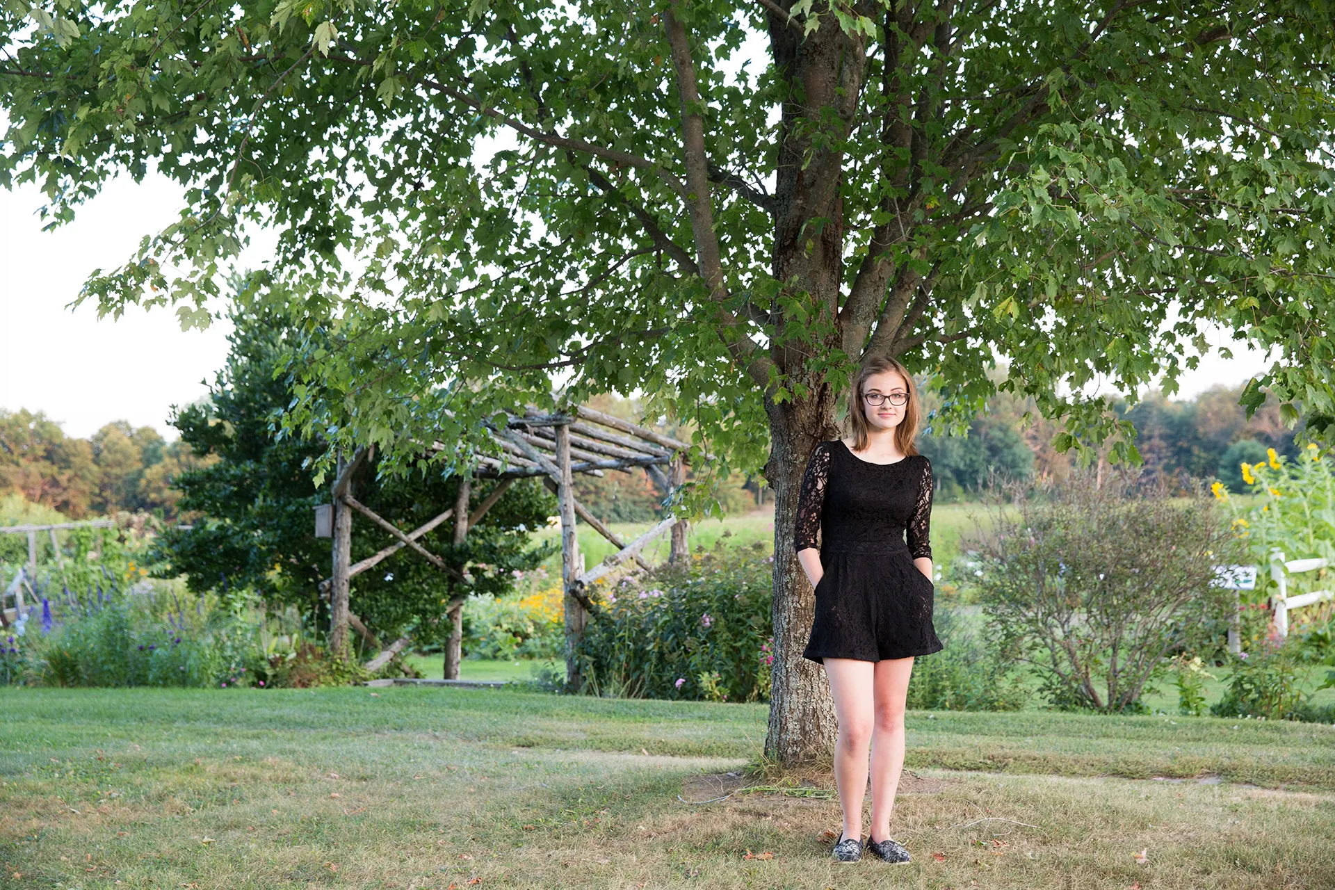 maine portrait photography emma 12 A high school senior poses in a garden during a senior portrait session at Rogers Farmer near the University of Maine in Old Town.