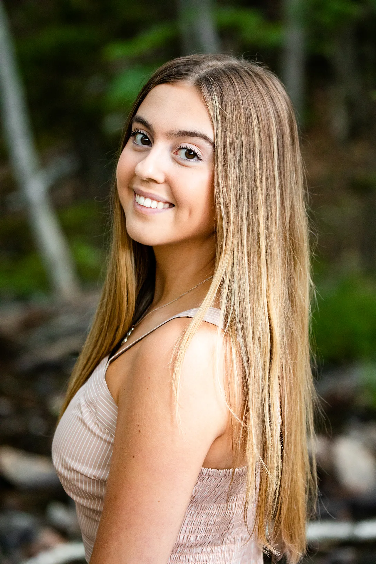 maine senior photography brooke 07 A high school senior looks over her shoulder as she smiles during a portrait session at Jordan Pond in Acadia National Park near Bar Harbor, Maine.