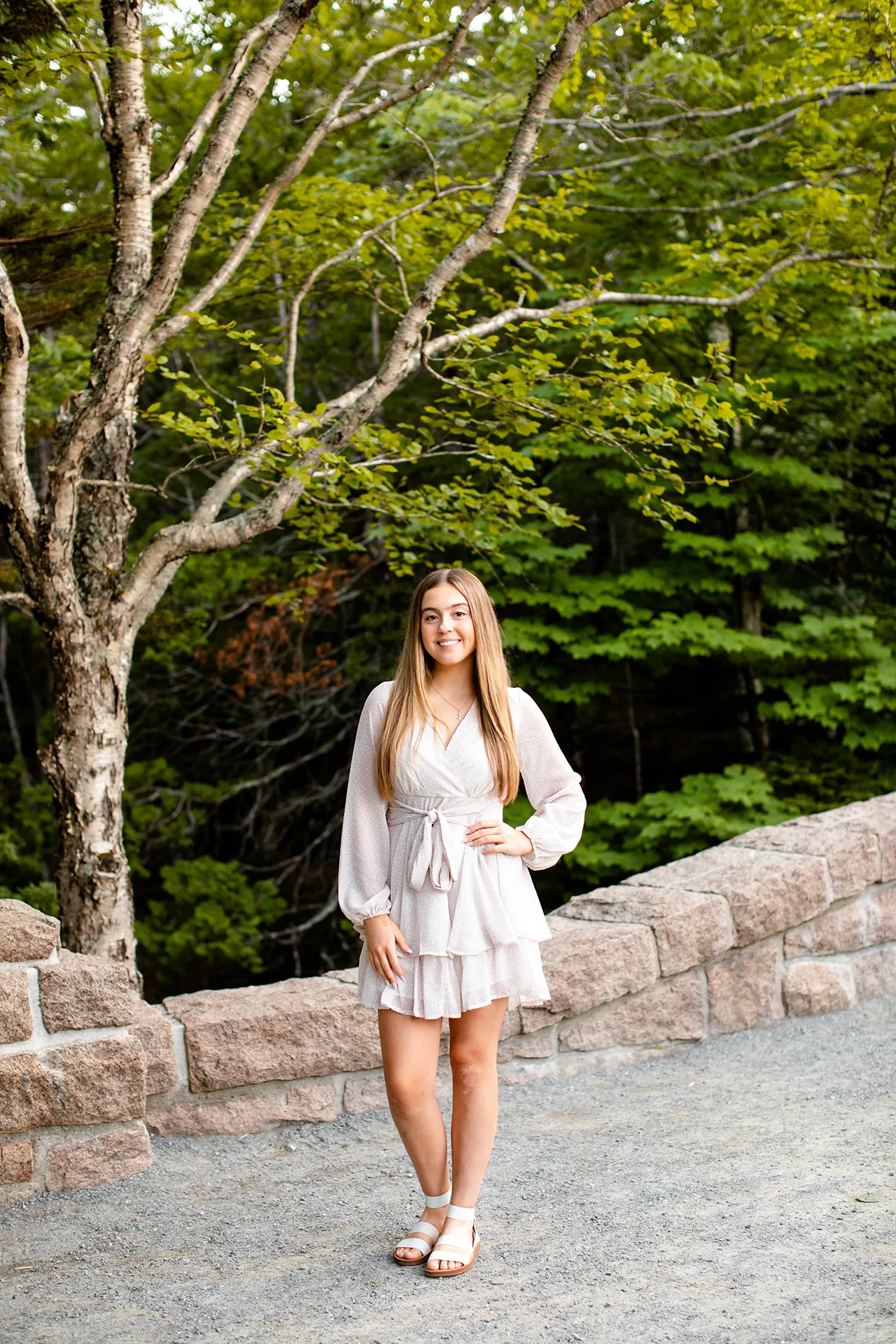 maine senior photography brooke 08 A girl smiles and poses on a stone bridge at Jordan Pond during a senior portrait session in Acadia National Park near Bar Harbor, Maine.