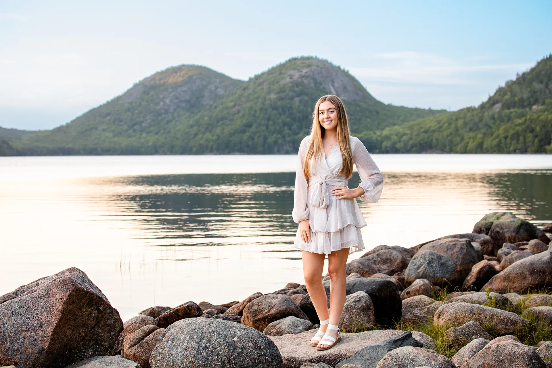 maine senior photography brooke 11 A girl smiles and poses in front of the bubbles at Jordan Pond during a senior portrait session in Acadia National Park near Bar Harbor, Maine.