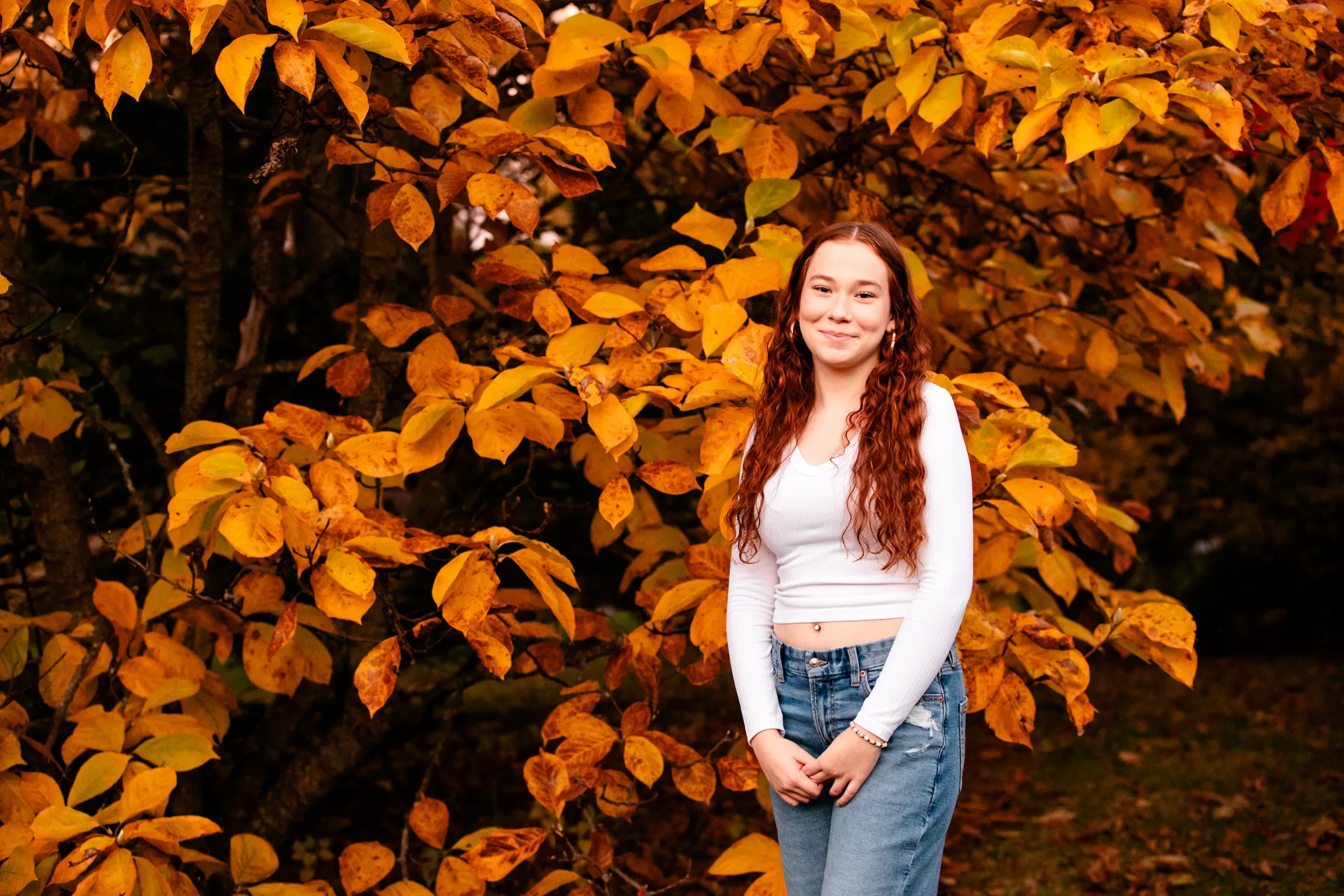 A girl poses for high school senior portraits at the LIttlefield Ornamentals Garden on the University of Maine campus.