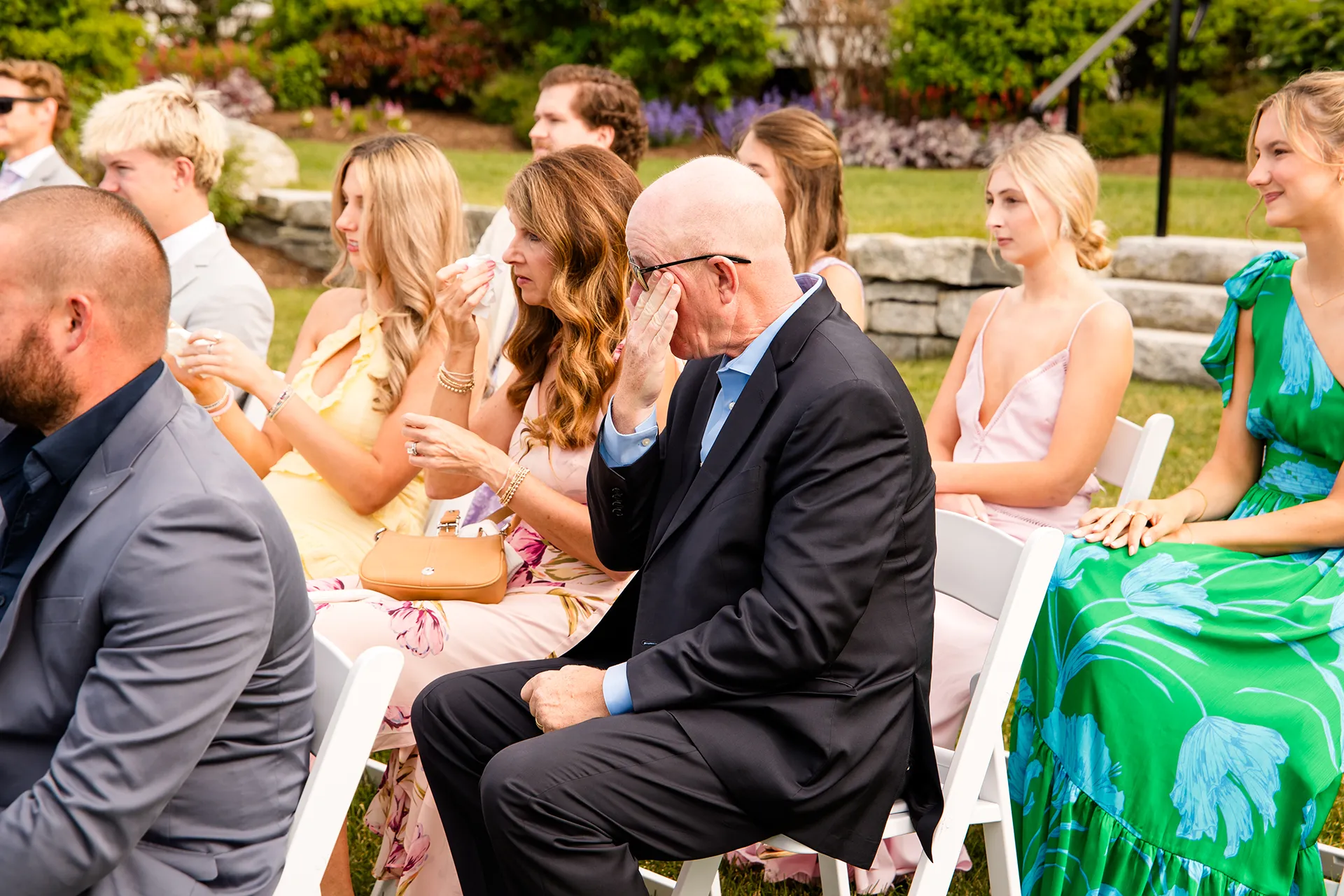 Wedding guests wipe away tears as they listen to a wedding ceremony at the Bar Harbor Inn and Spa in Maine.