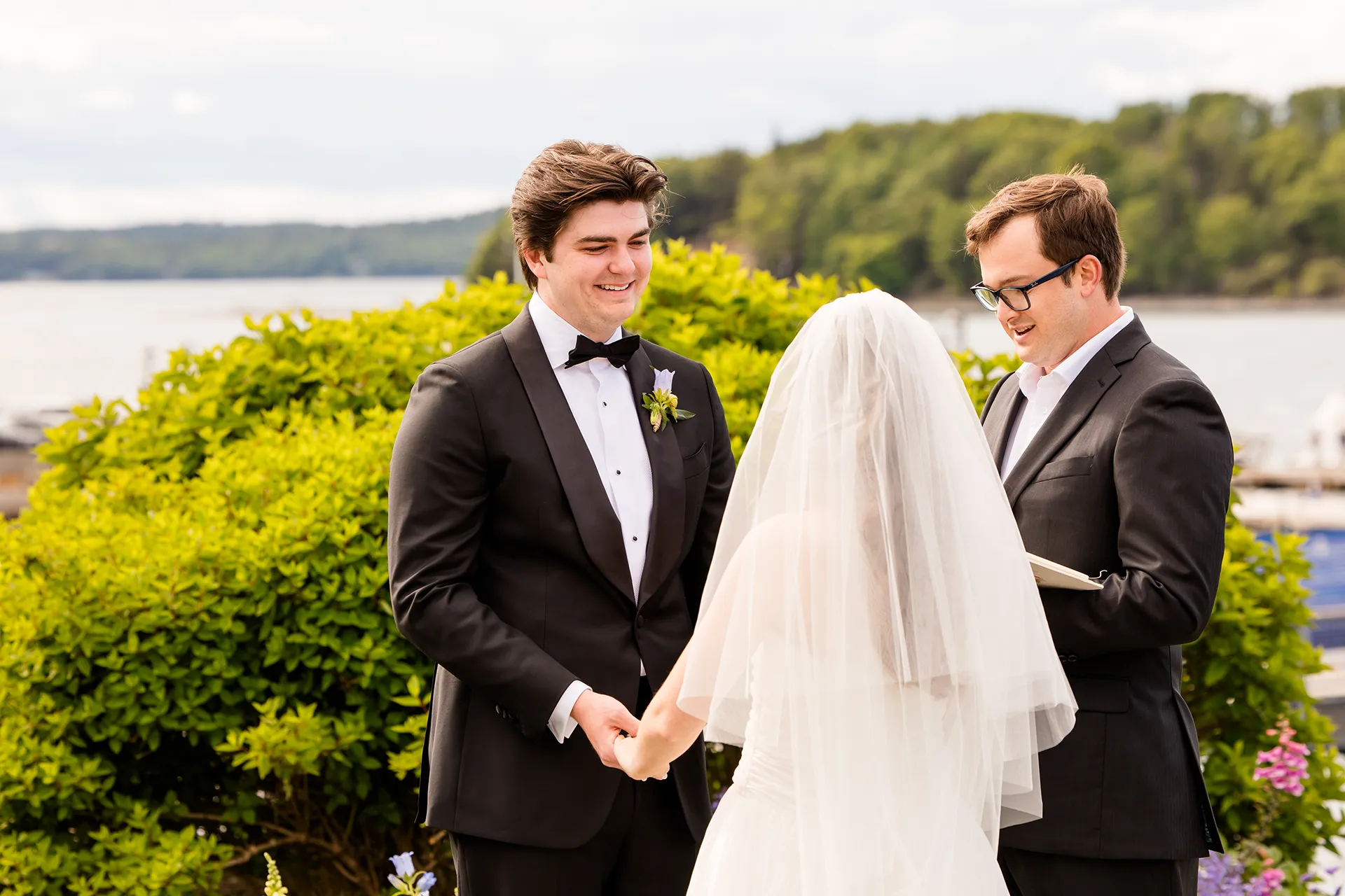 A groom smiles at his bride during a wedding ceremony at the Bar Harbor Inn and Spa near Acadia National Park in Maine.