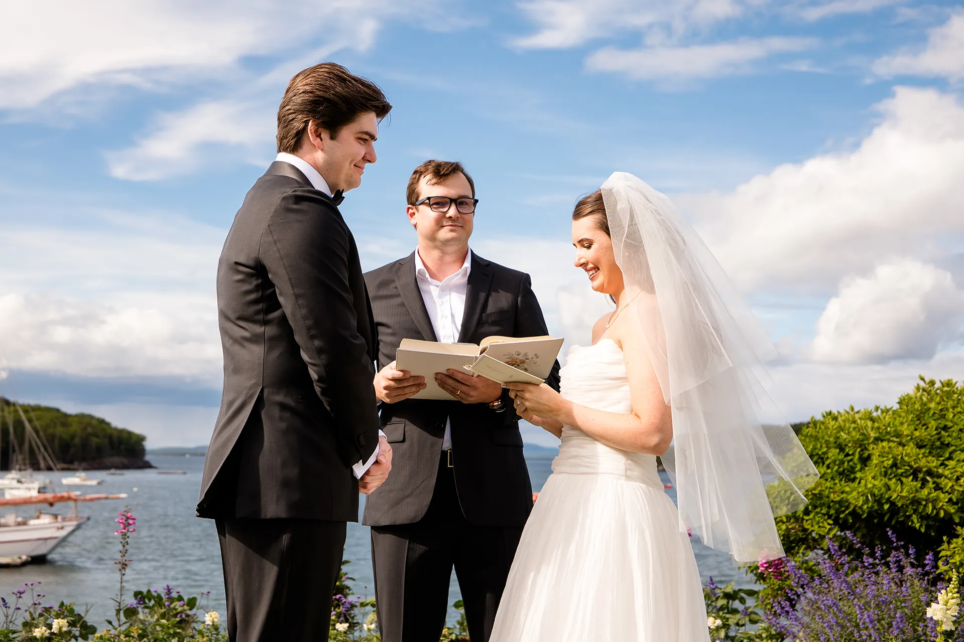 A bride reads her vows to a groom during a wedding ceremony at the Bar Harbor Inn and Spa near Acadia National Park in Maine.