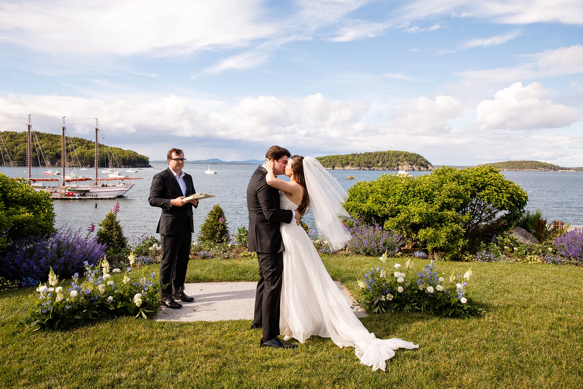A newly married couple kisses during a wedding ceremony at the Bar Harbor Inn and Spa near Acadia National Park in Maine.