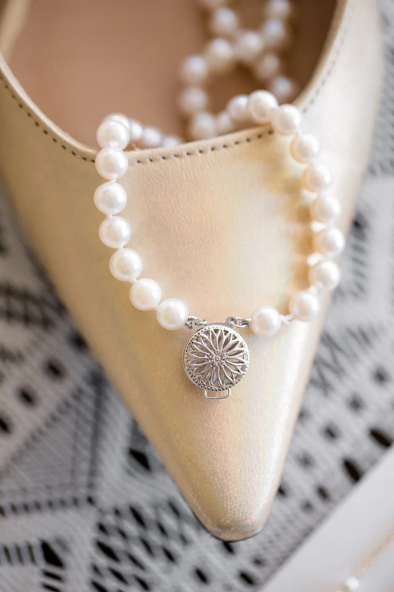 A closeup of a bracelet sitting on a pair of tan high heels at the Atlantic Oceanside and Event Center in Bar Harbor, Maine.
