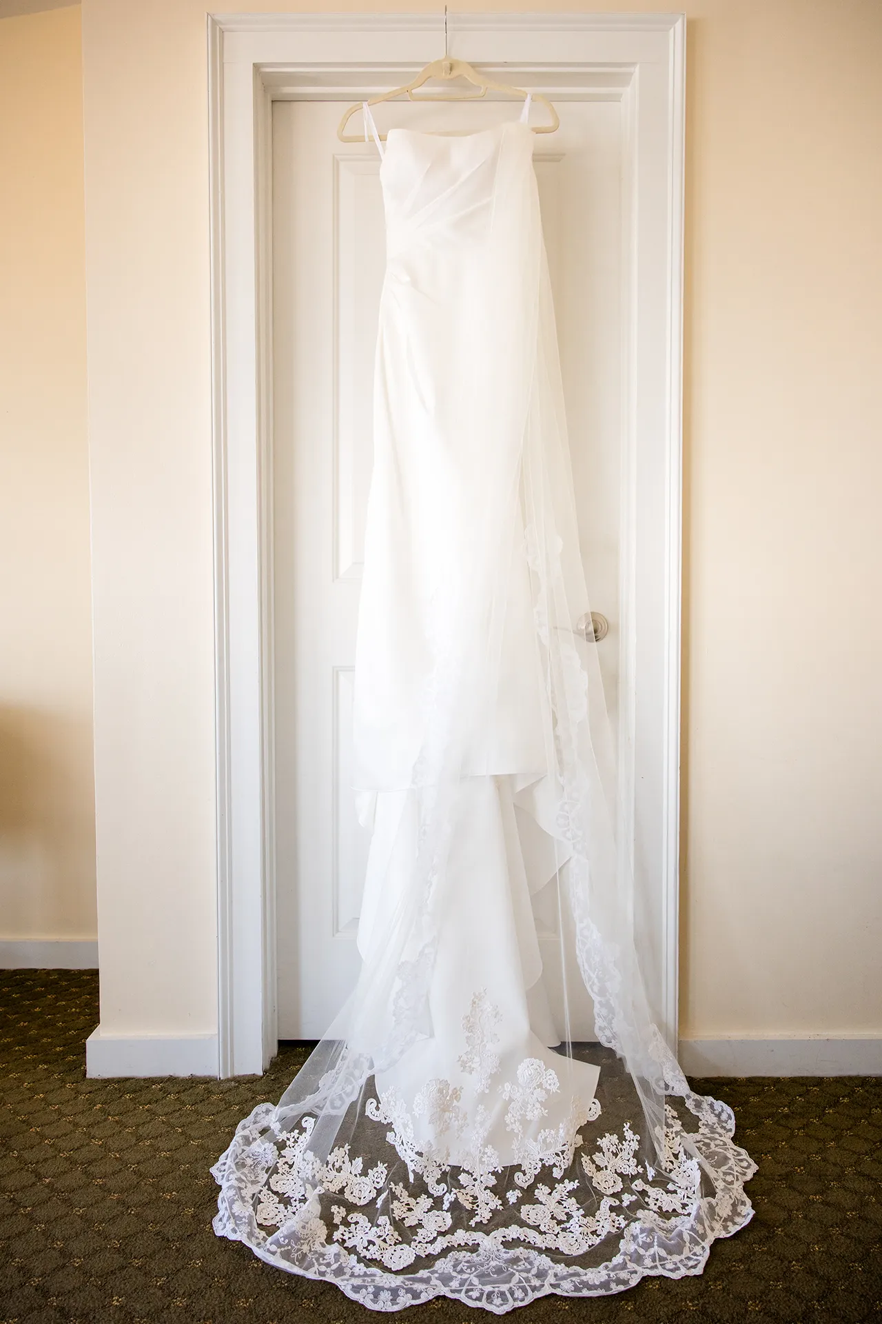 An ivory wedding dress hangs from a door at the Atlantic Oceanside and Event Center in Bar Harbor, Maine.