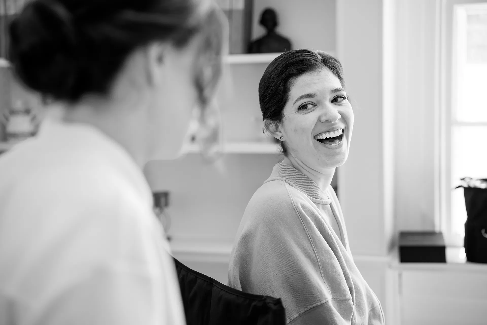 A woman laughs while getting ready for a wedding at the Atlantic Oceanside and Event Center in Bar Harbor, Maine.