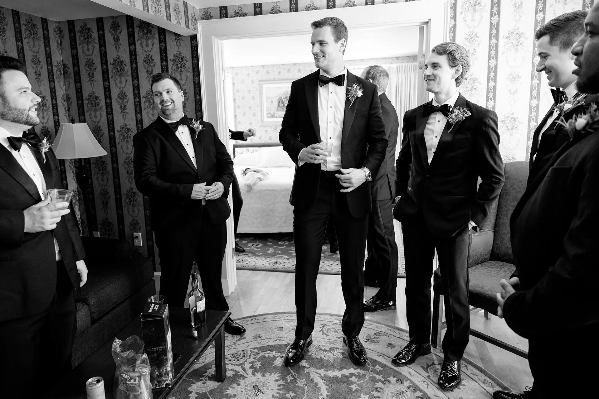 A groomsmen enjoy a drink as they get ready for a wedding at the Atlantic Oceanside and Event Center in Bar Harbor, Maine.