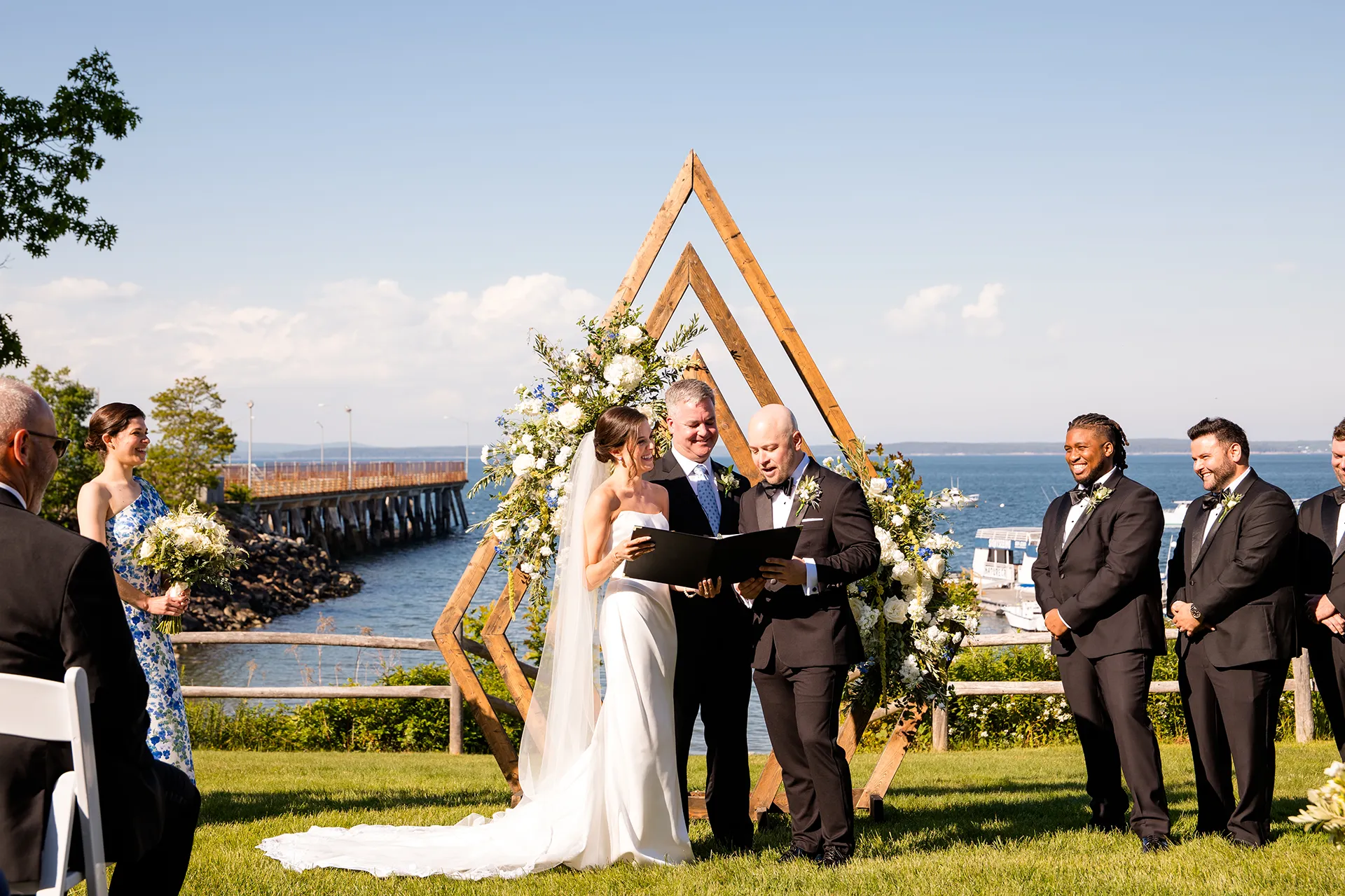 Bride and groom smile as they read their vows during a wedding ceremony at the Atlantic Oceanside Hotel & Event Center in Bar Harbor, Maine.