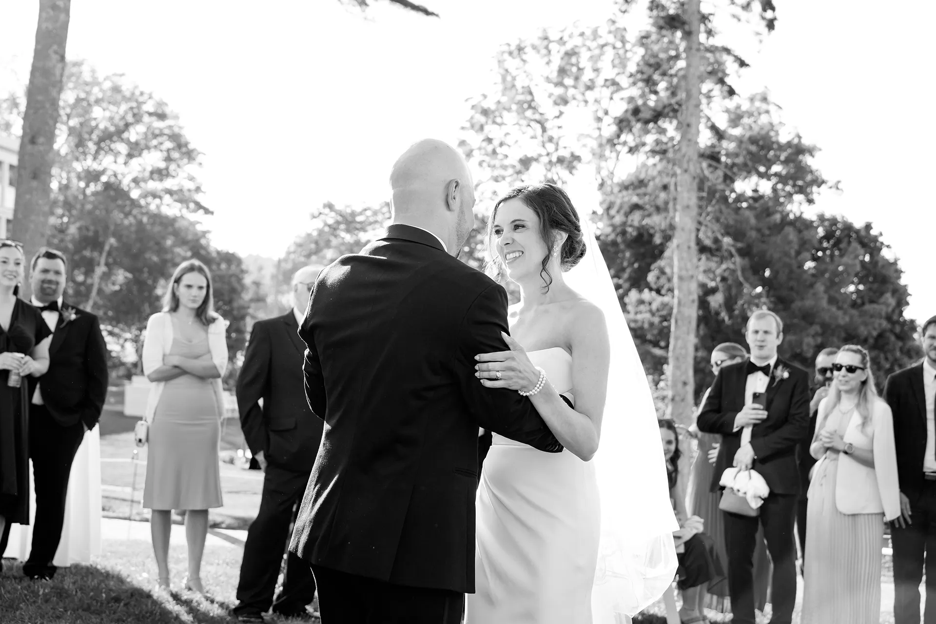 A bride smiles at a groom as they share a first dance outside at the Atlantic Oceanside Hotel & Event Center in Bar Harbor, Maine.