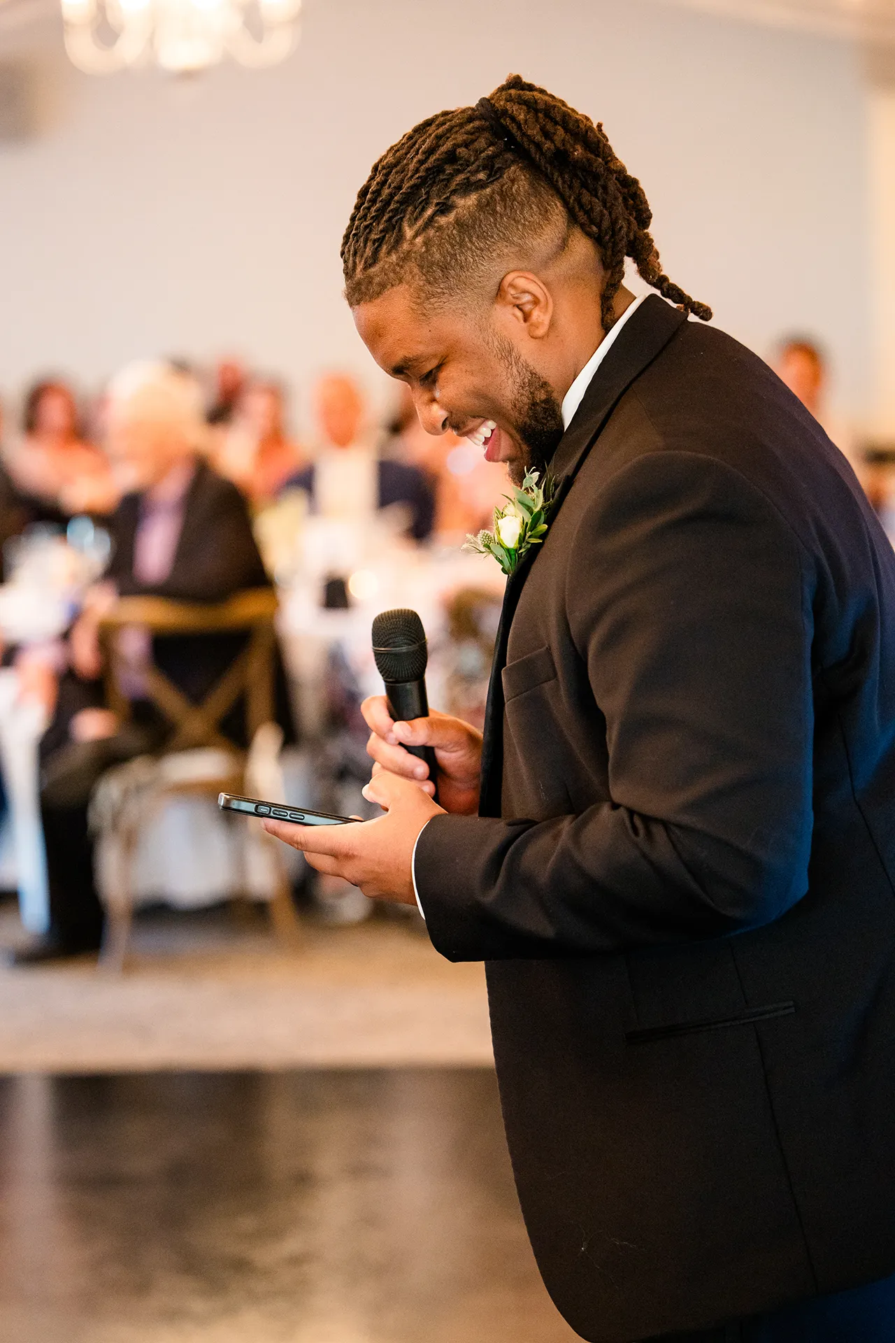 A best man laughs as he gives a toast during a wedding reception at the Atlantic Oceanside Hotel & Event Center in Bar Harbor, Maine.