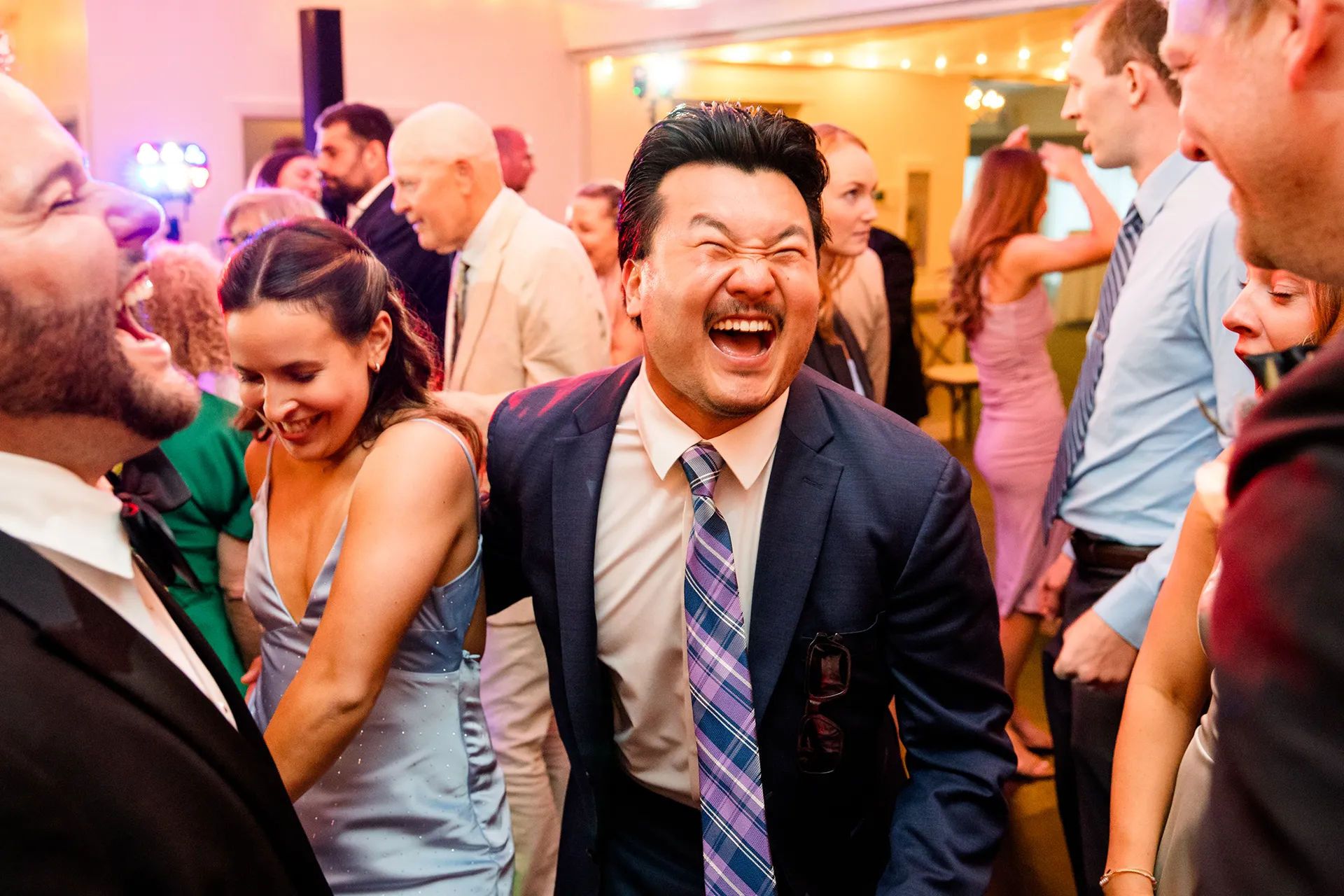 A man laughs while dancing during a wedding reception at the Atlantic Oceanside Hotel & Event Center in Bar Harbor, Maine.