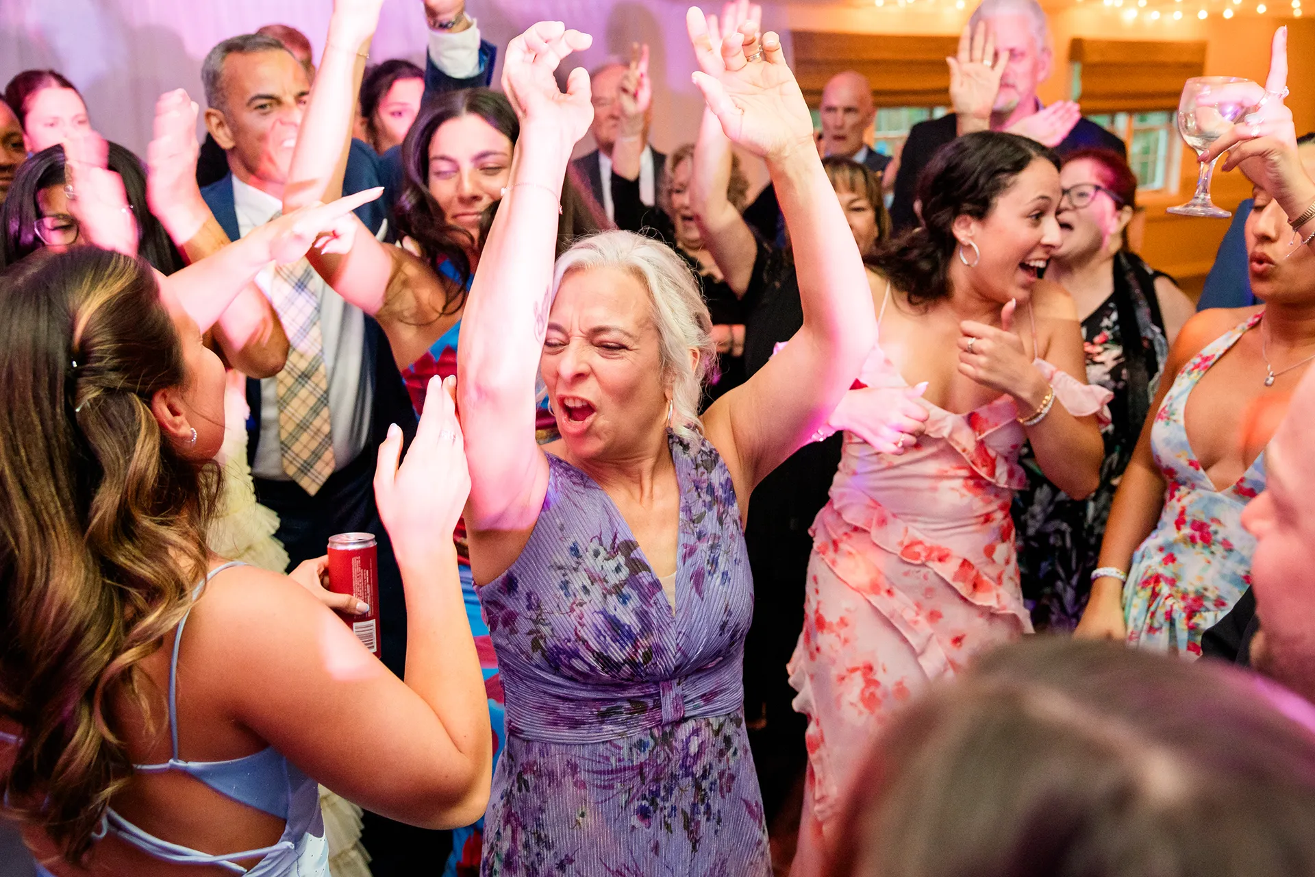 A woman celebrates as she dances during a wedding reception at the Atlantic Oceanside Hotel & Event Center in Bar Harbor, Maine.