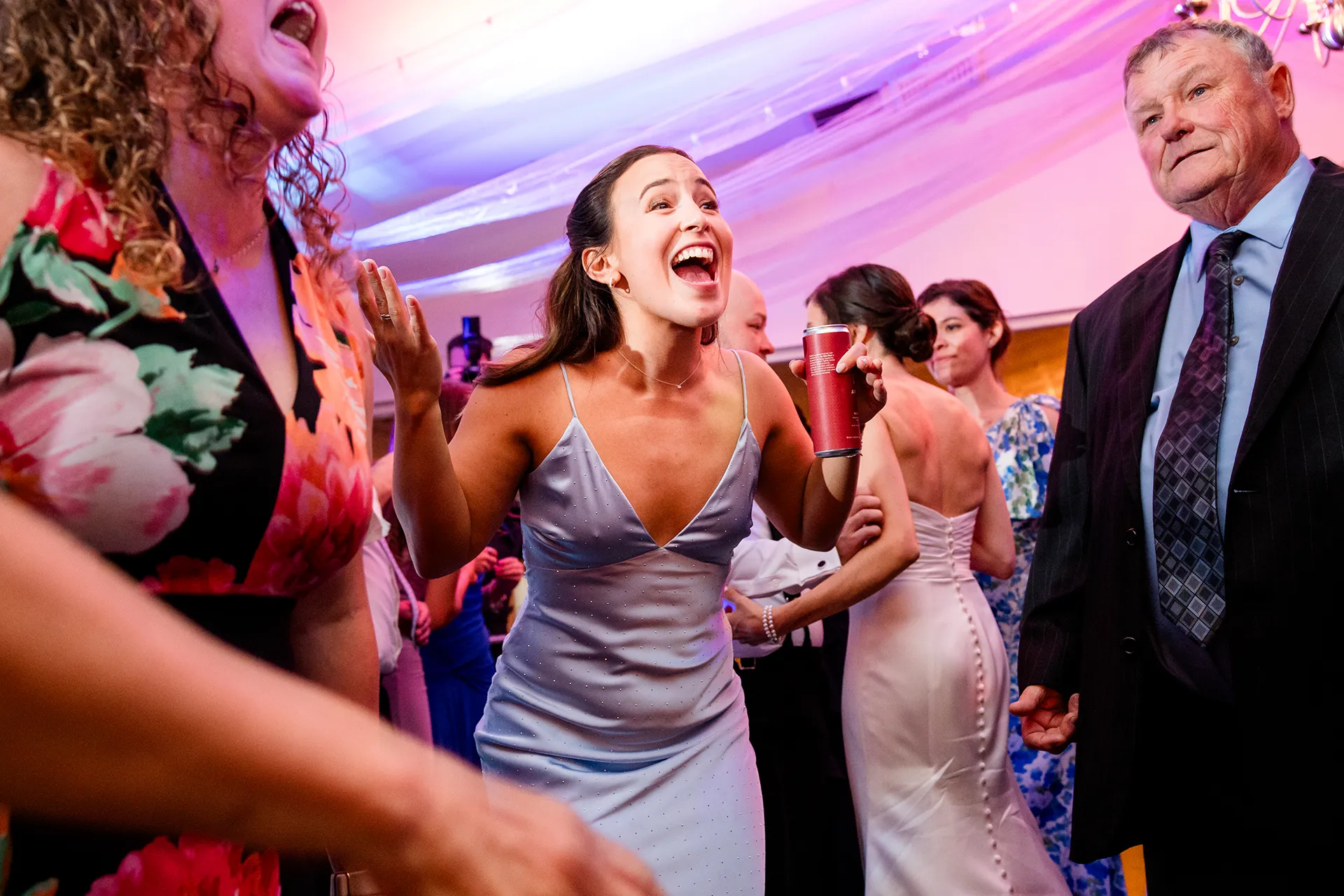 A bridesmaid yells as she dances during a wedding reception at the Atlantic Oceanside Hotel & Event Center in Bar Harbor, Maine.