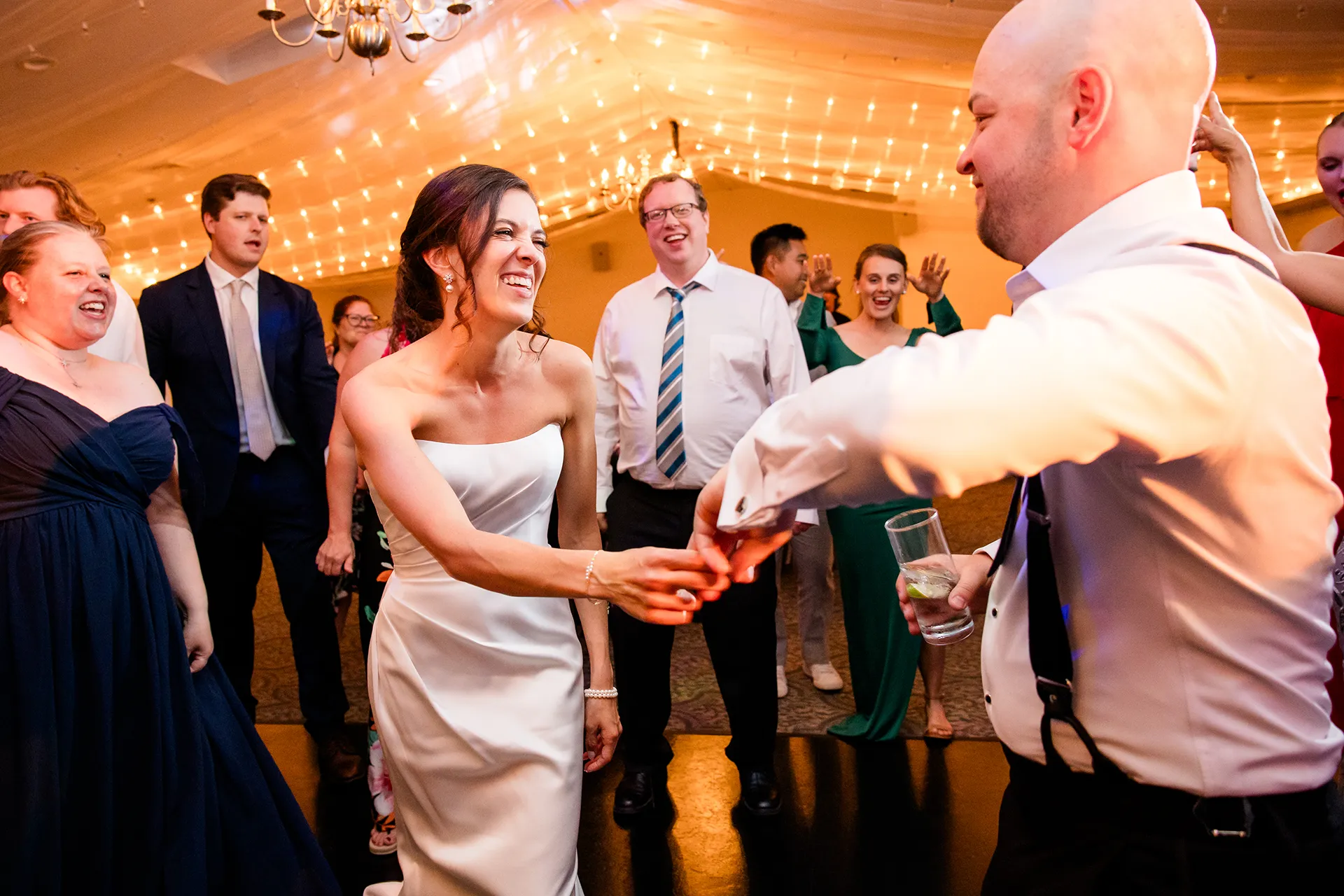 A bride laughs as she dances with a groom during a wedding reception at the Atlantic Oceanside Hotel & Event Center in Bar Harbor, Maine.