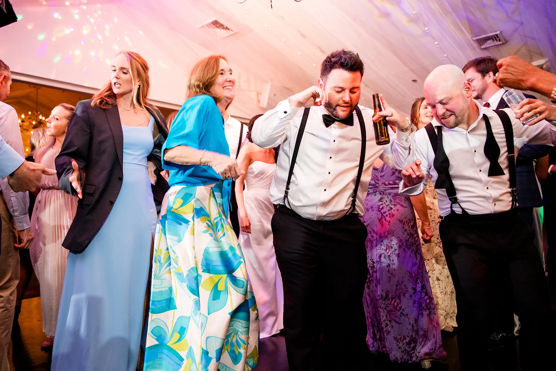 A groom dances with a groomsman during a wedding reception at the Atlantic Oceanside Hotel & Event Center in Bar Harbor, Maine.
