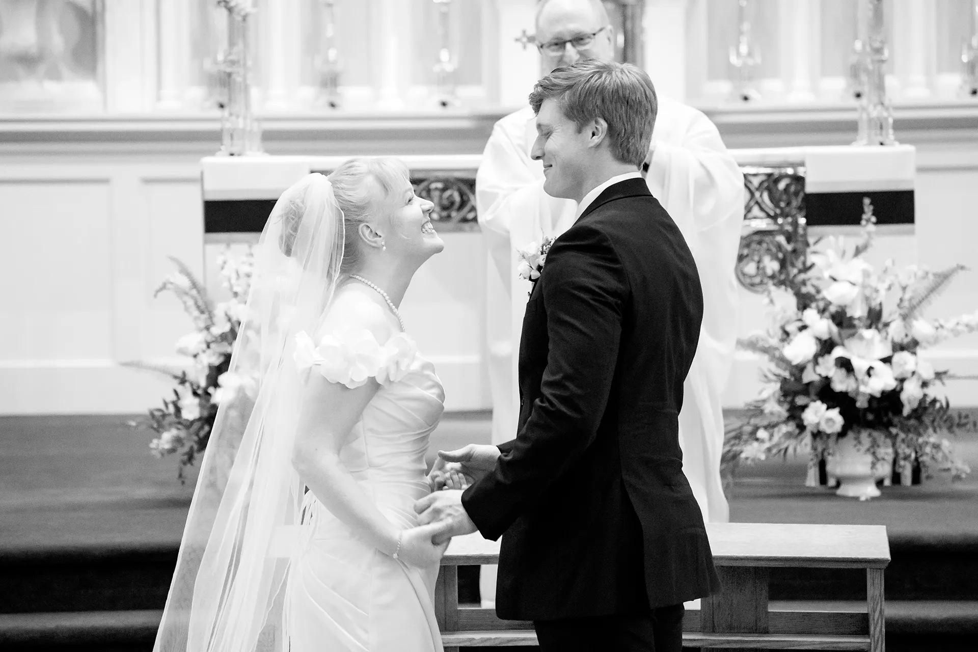 A newly married couple smile at each other after getting married at Saint John's Catholic Church in Bangor, Maine.
