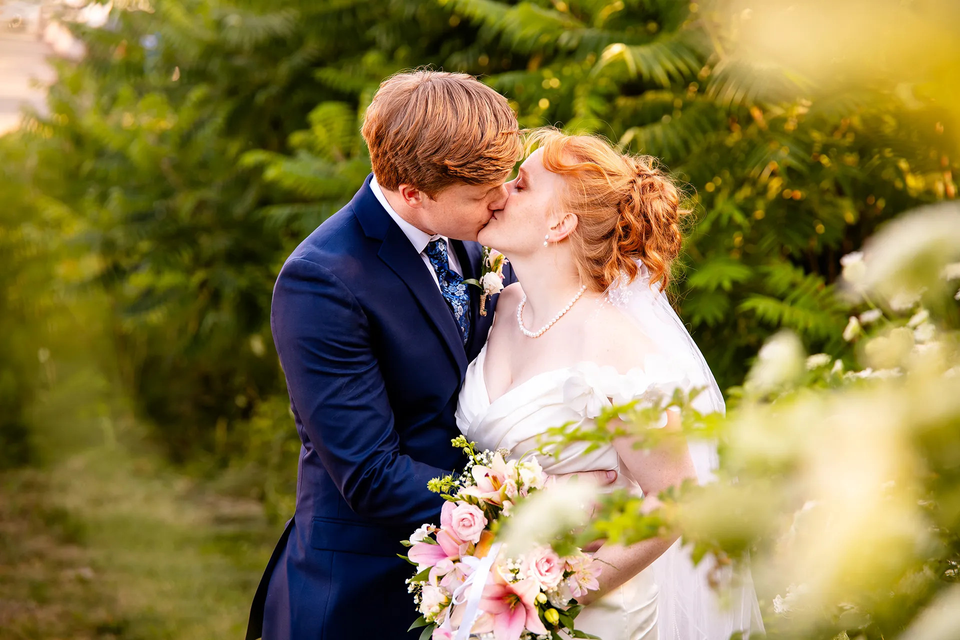 A bride and groom kiss during wedding portraits at the Hilton Garden Inn in Bangor, Maine.