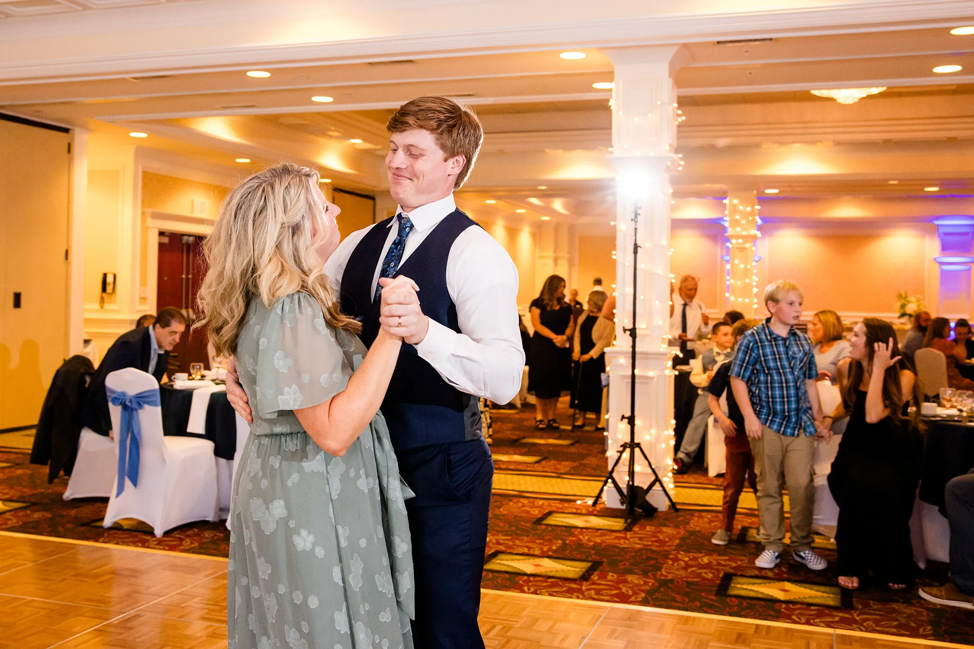 A groom and his mom smile as they share a dance during a wedding reception at Hilton Garden Inn in Bangor, Maine.